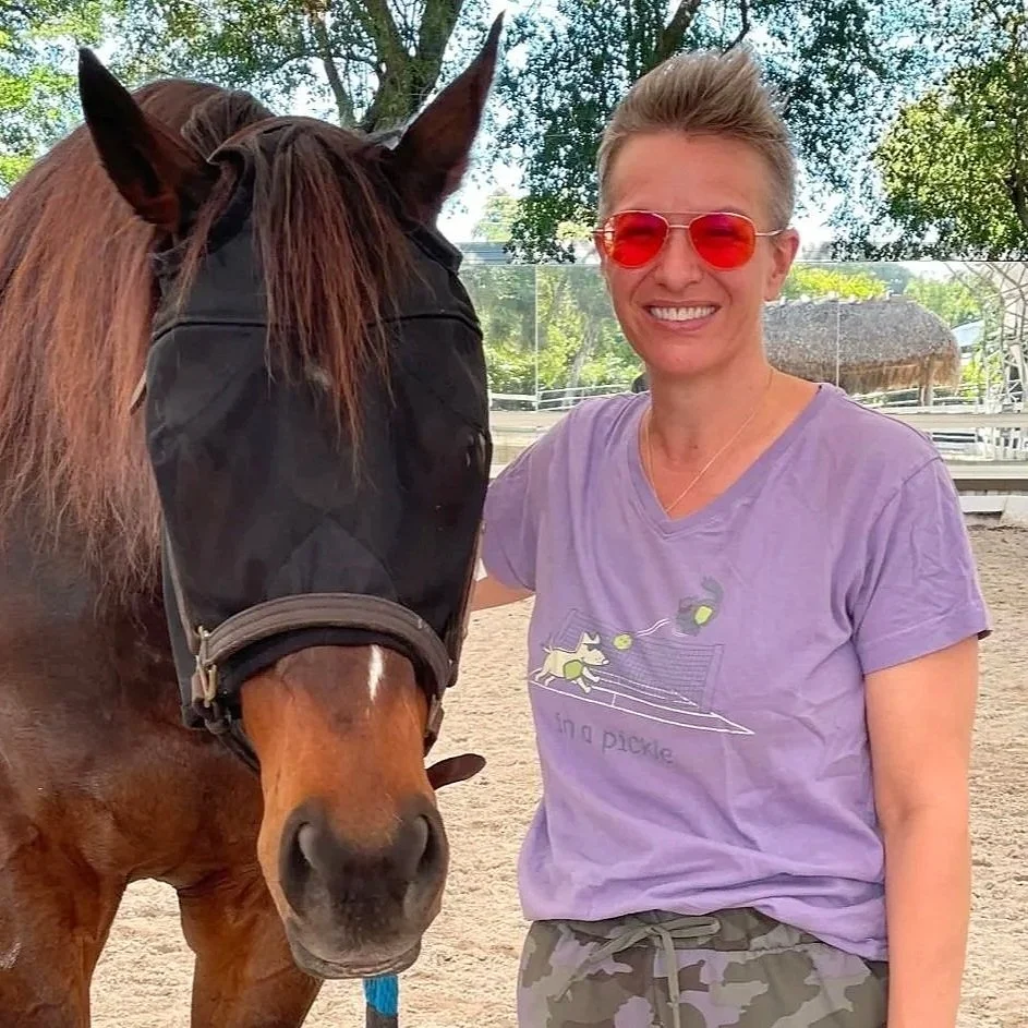Angela Lowe smiling with Horse in HERD stadium