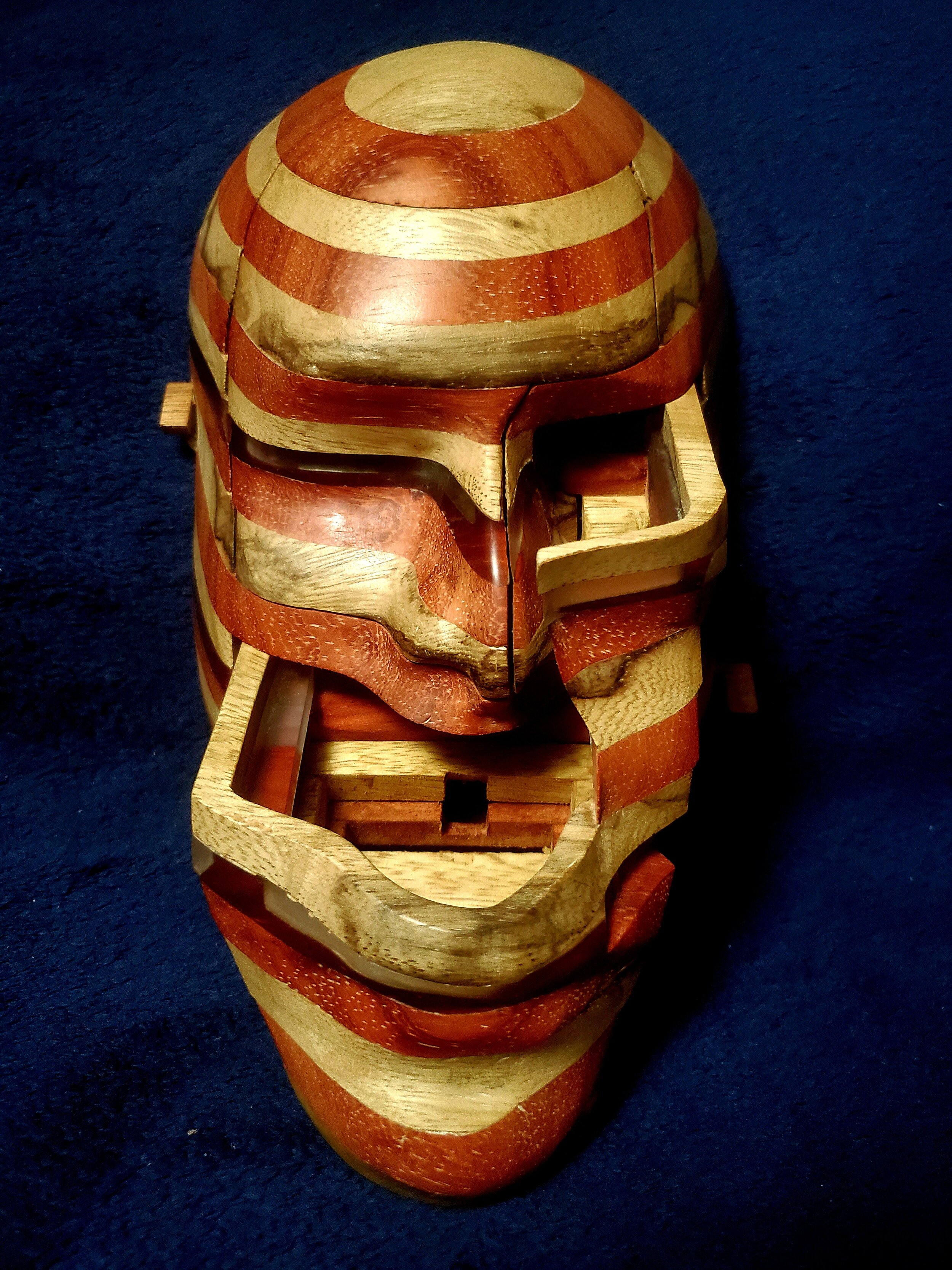 Wooden face sculpture with a drawer open