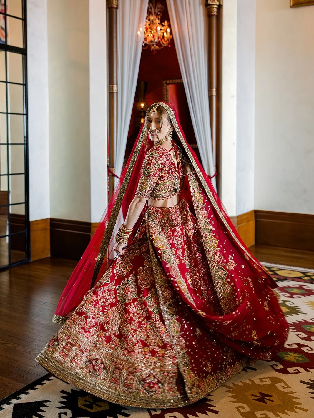 She was a stunning Jewish bride who embraced Indian tradition with her whole heart. In her bridal attire, she wanted nothing less than the full spectrum of beauty: the riot of colors, the regal opulence, and the grace of a veil crowning it all.

Brid