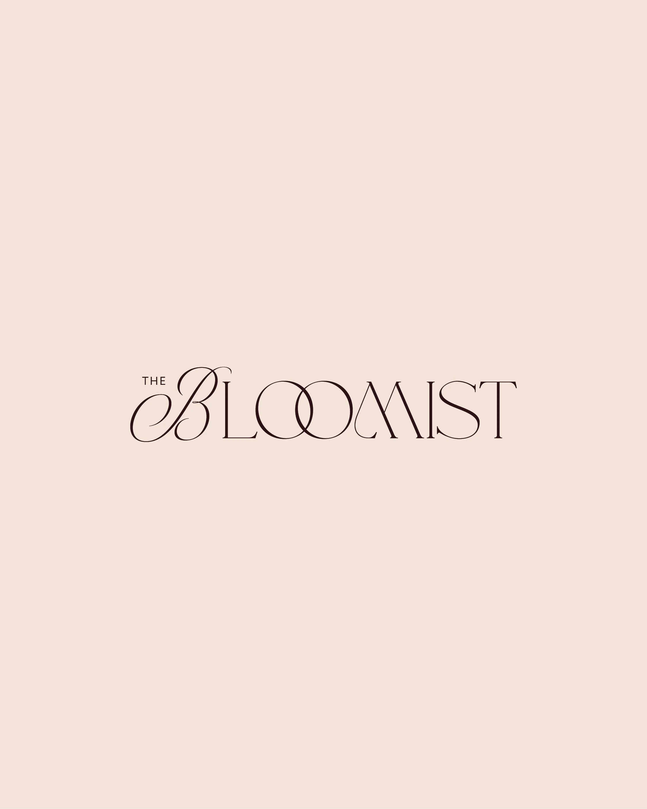 Partial view of a book cover titled 'The Bloomist' with beige background and elegant black cursive text.