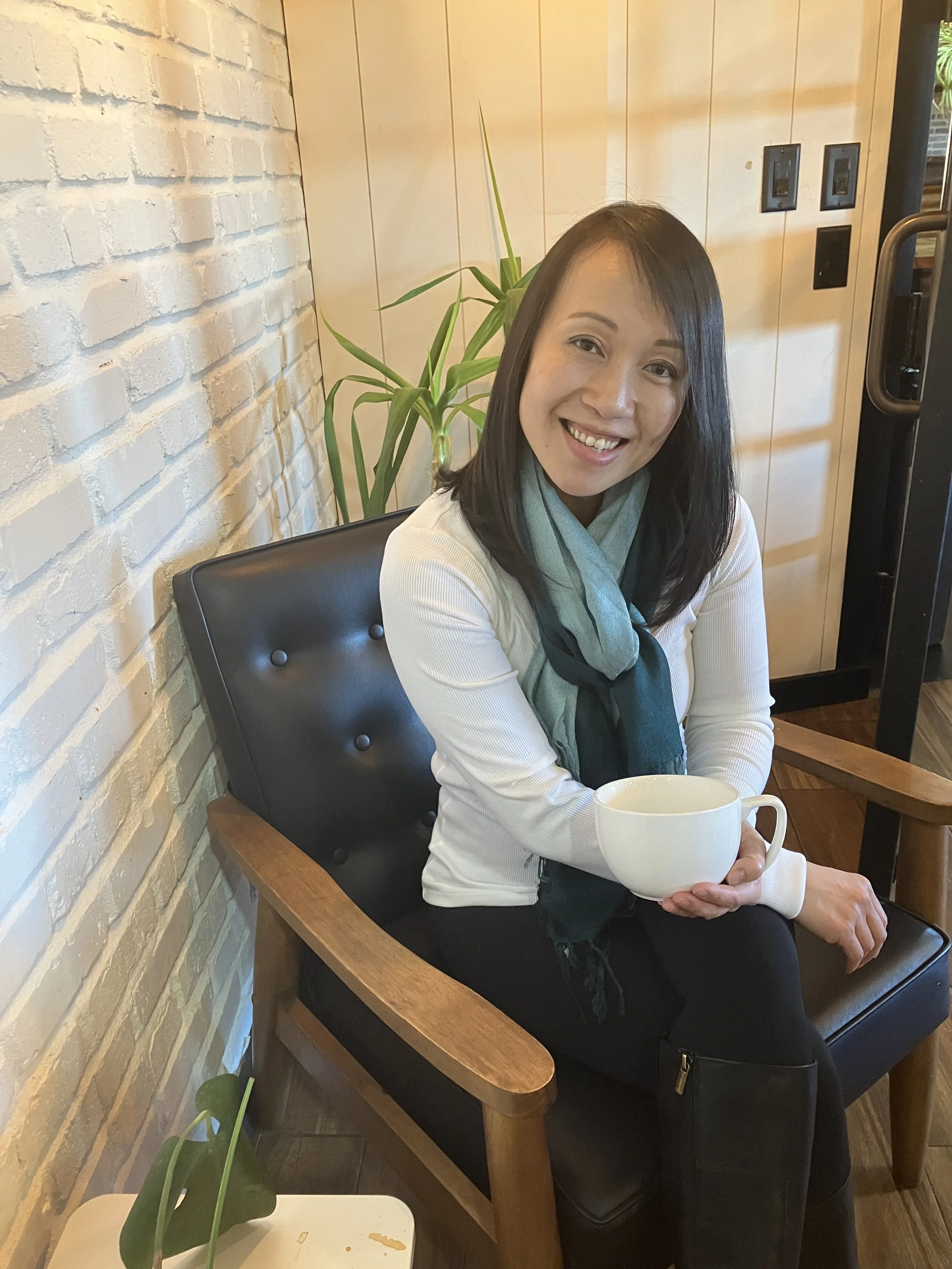 Therapist Katie Egge sitting in a cozy chair holding a mug, offering a warm and supportive space for adult children of emotionally immature parents