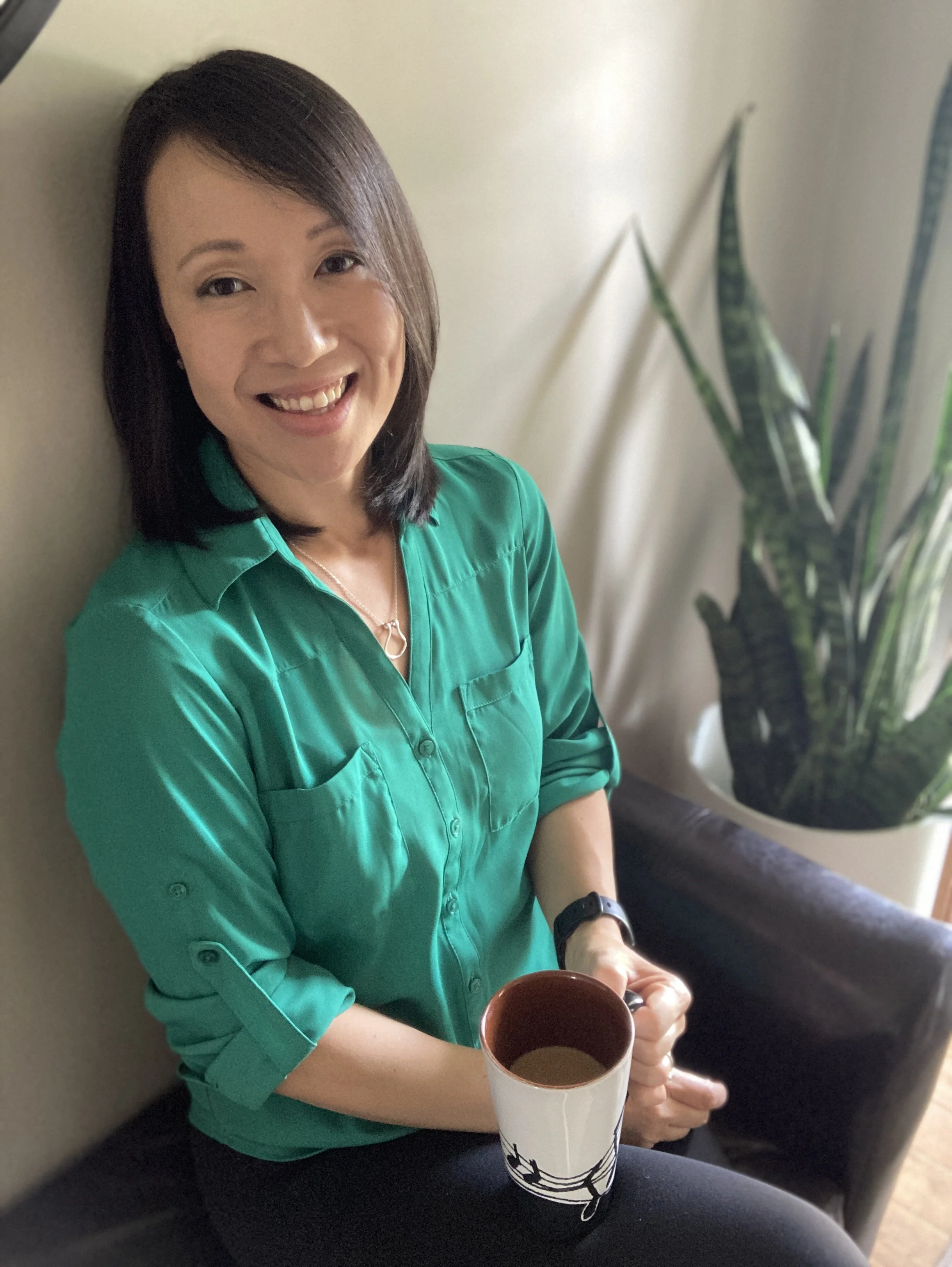Therapist Katie Egge who helps adults heal from childhood emotional neglect and emotionally immature parenting, sitting on bench and smiling