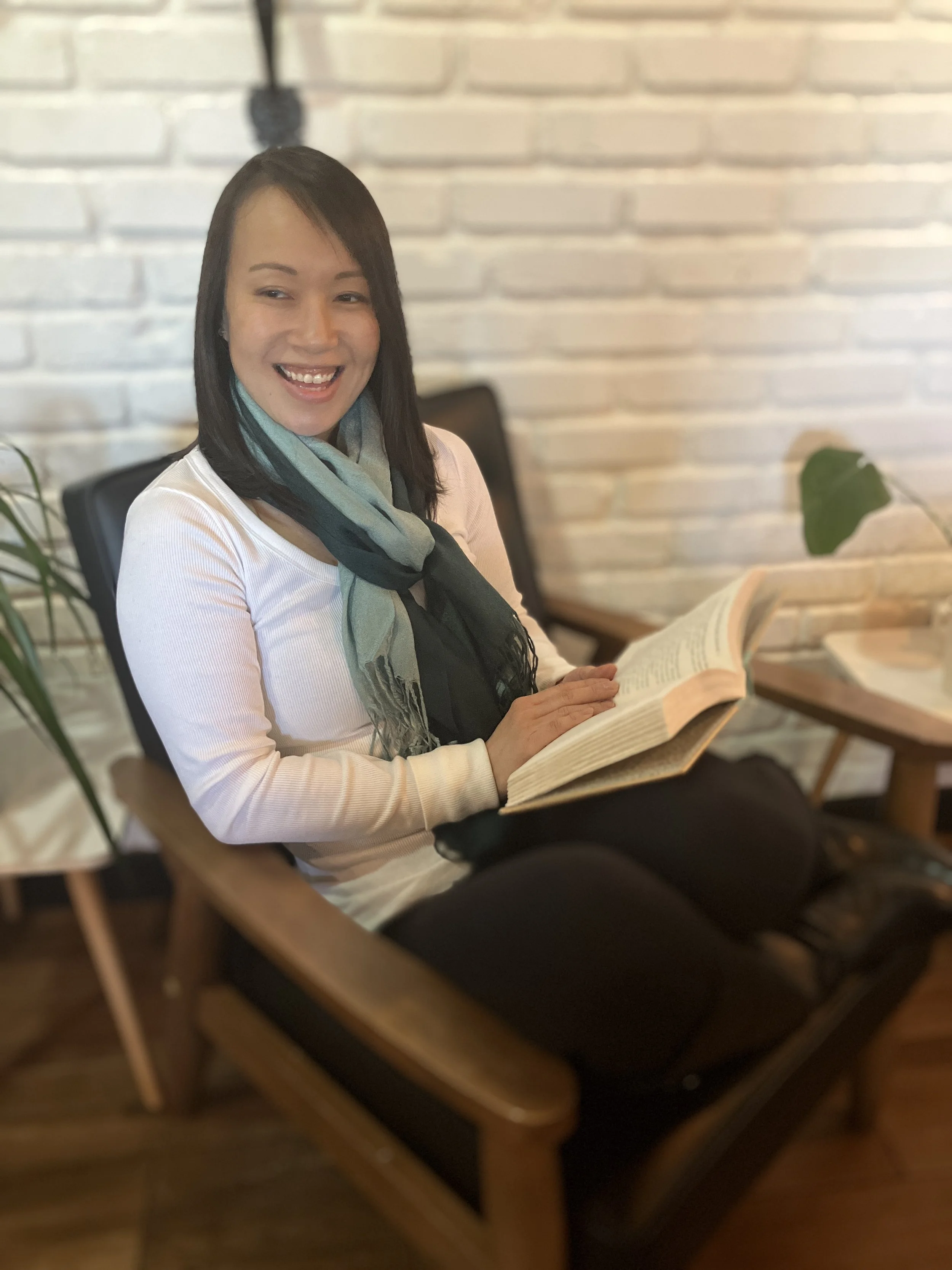 Katie Egge, therapist who works with adult children of emotionally immature parents, sitting in a warm and inviting therapy space