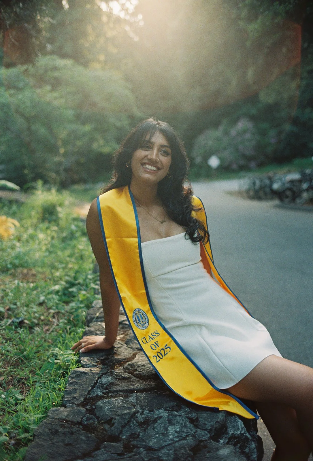 A film photo of a University of California Santa Cruz graduate with her sash