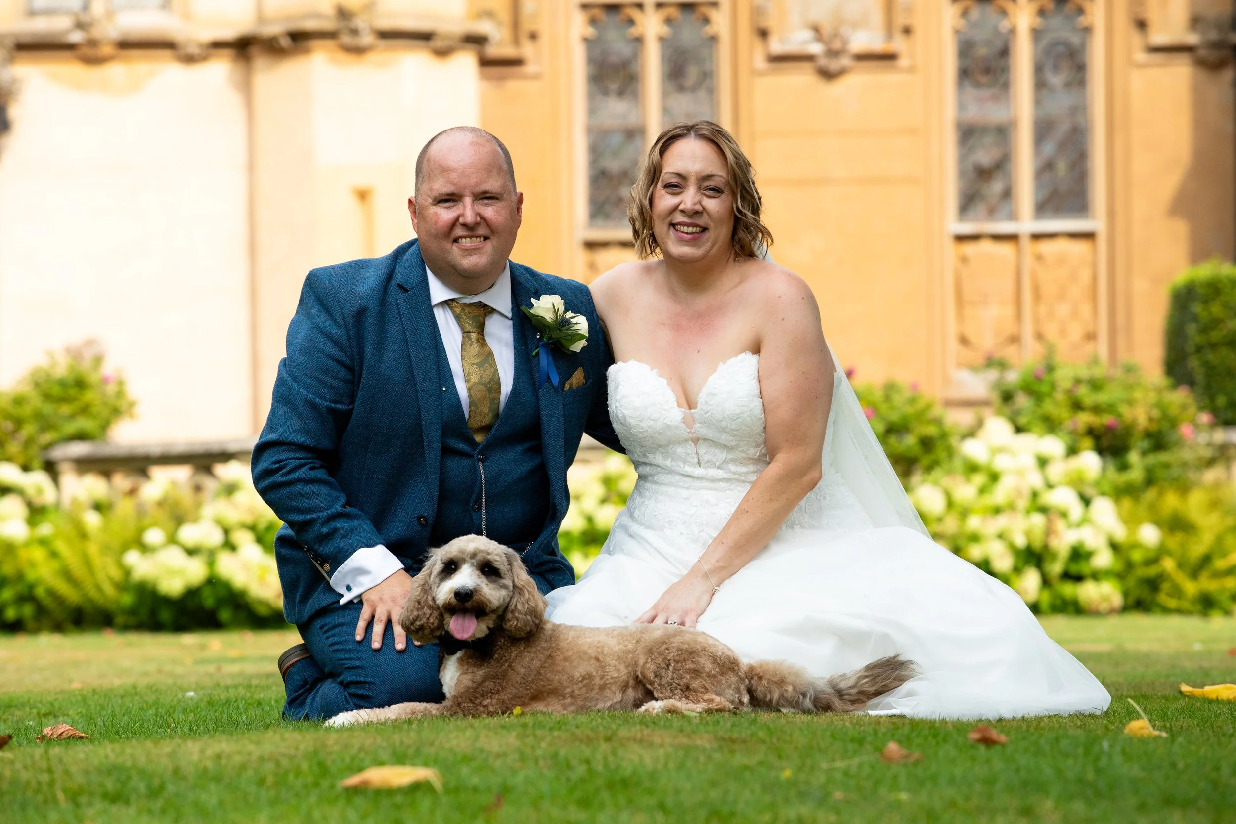 A couple portrait with their dog on the scenic grounds of Knebworth house in Hertfordshire.