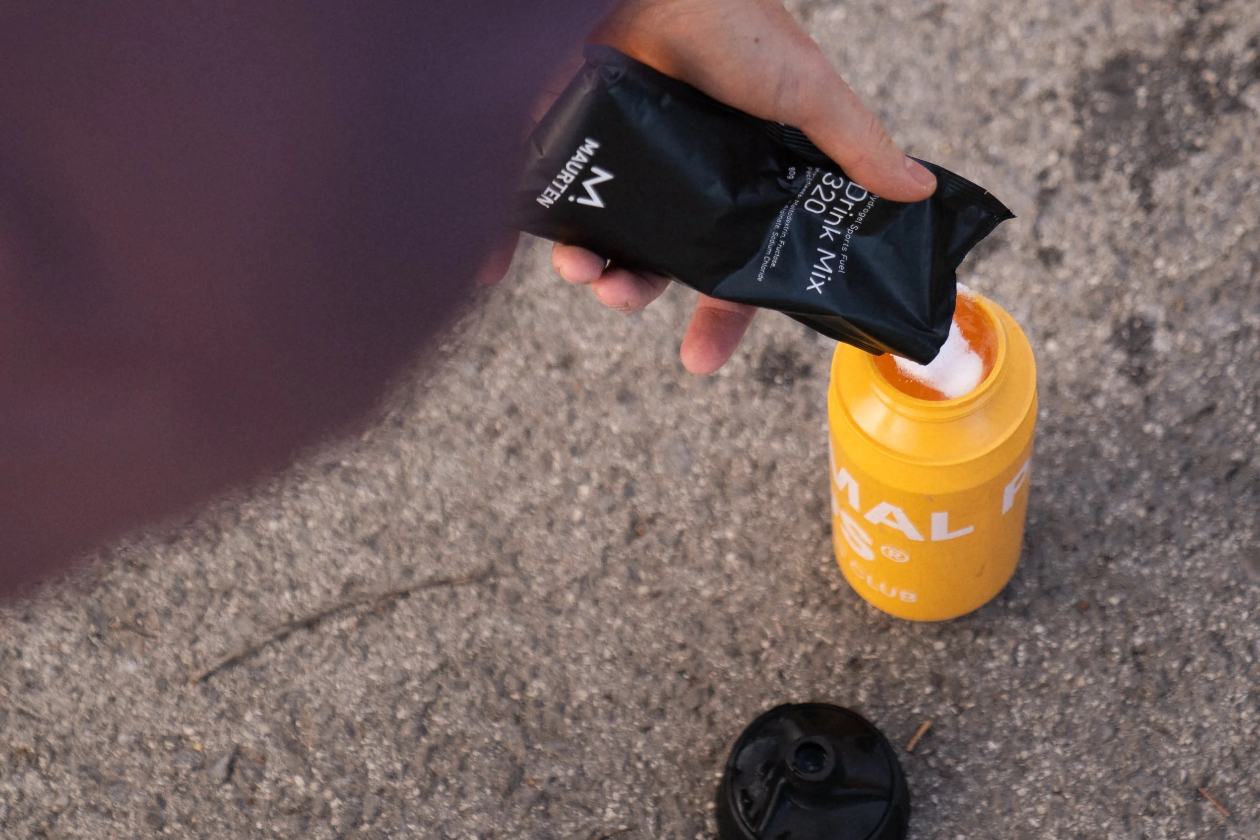 Cyclist mixing Maurten Drink Mix 320 during a ride, compared to a homemade sports drink based on maltodextrin and dextrose that costs a fraction of the price.