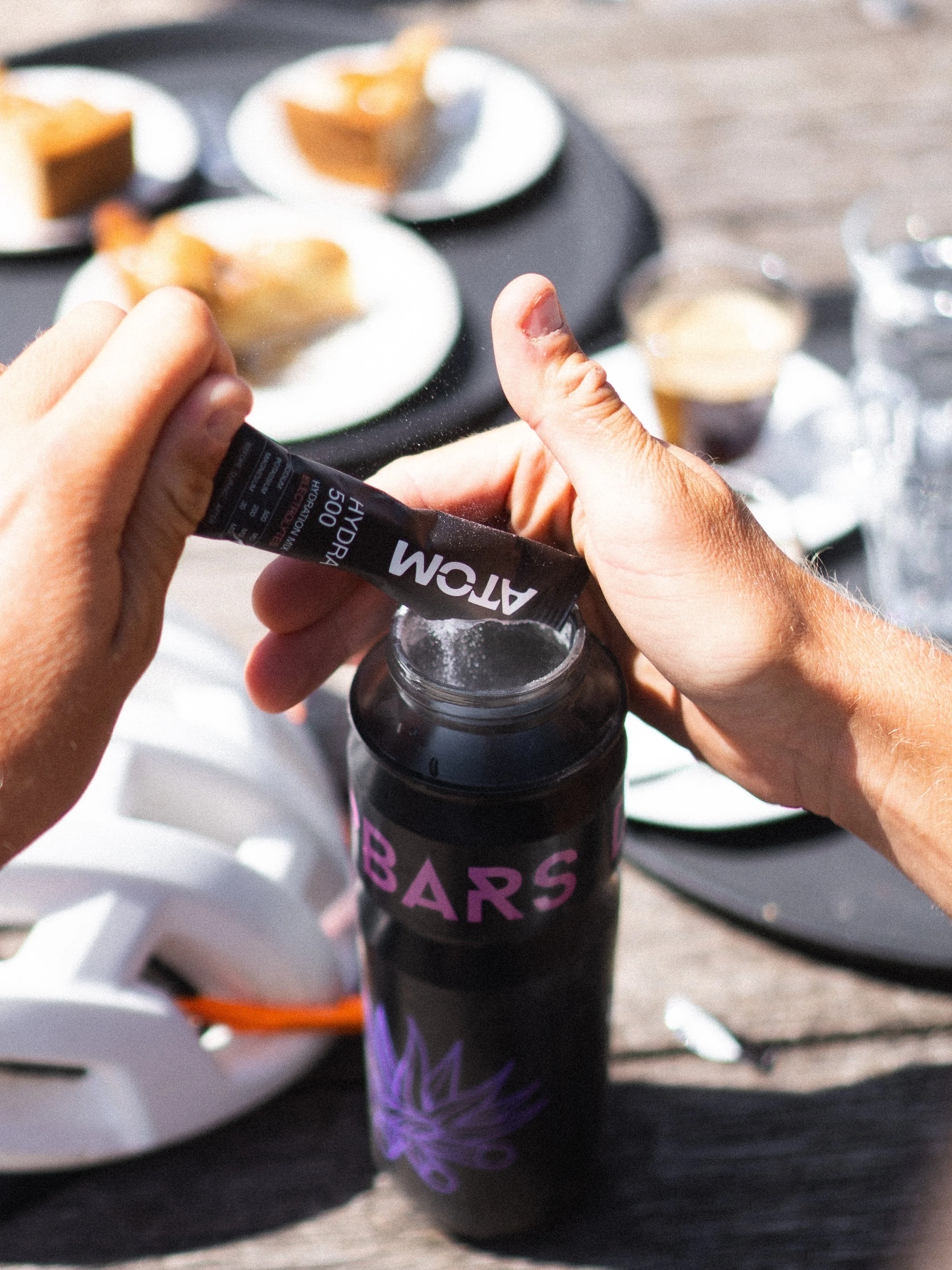 cyclist-adding-electrolyte-powder-water-bottle-ride.jpg