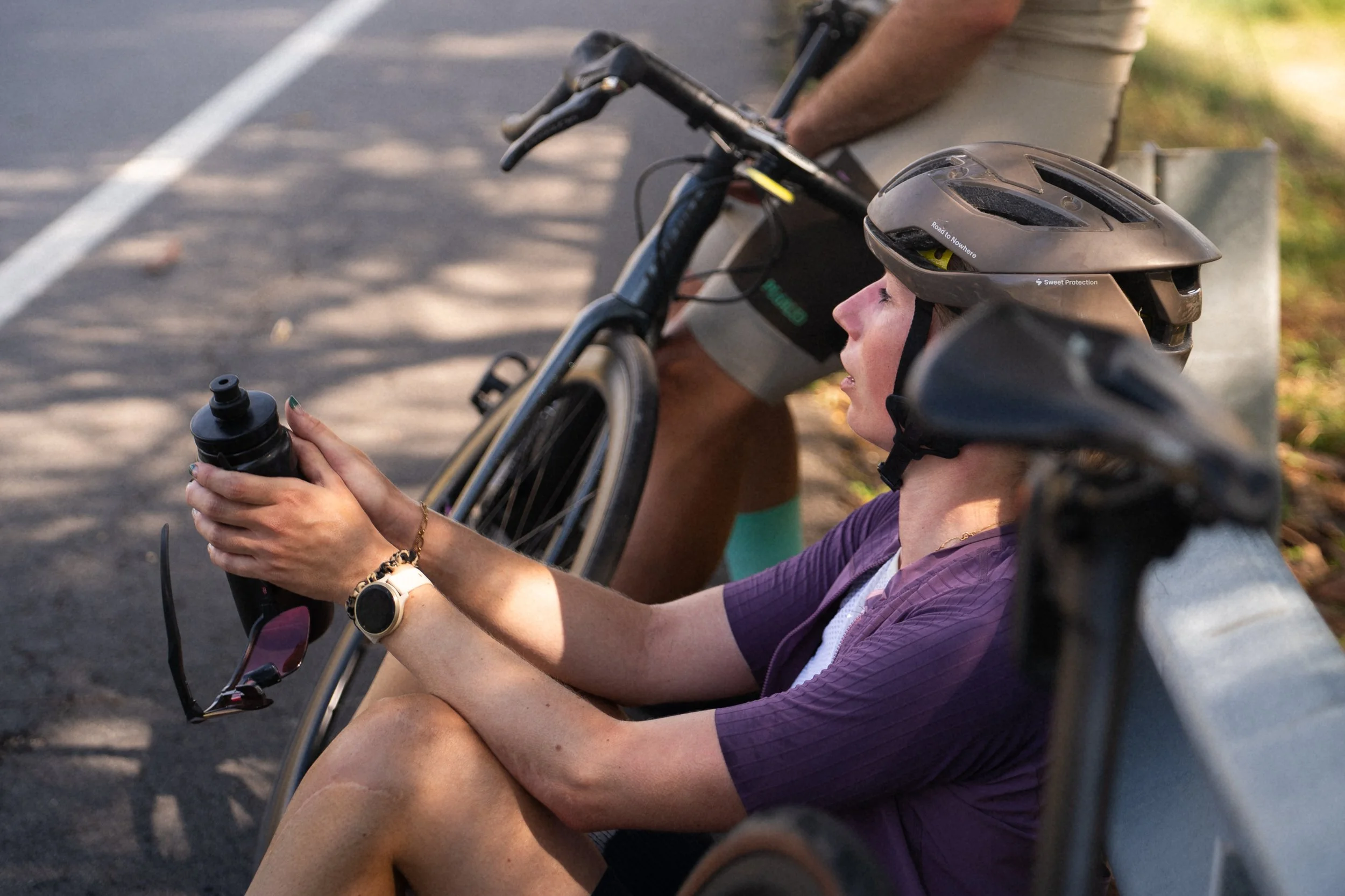 Cyclist suffering from dehydration in hot conditions, illustrating the importance of proper carbohydrate and electrolyte ratios in sports nutrition.