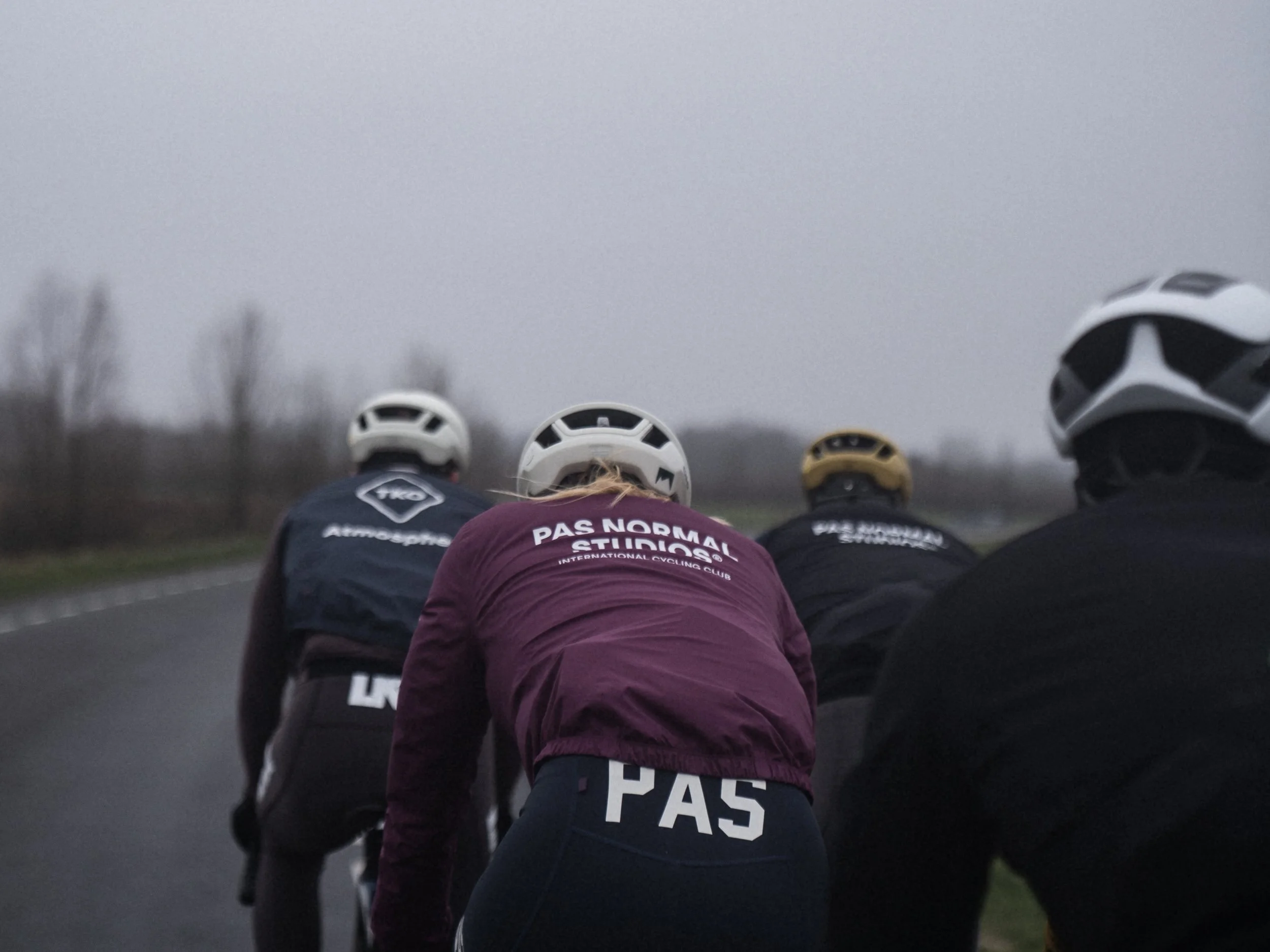 Group of cyclists battling the Dutch winter wind at the Willem Alexander Roeibaan Rotterdam.