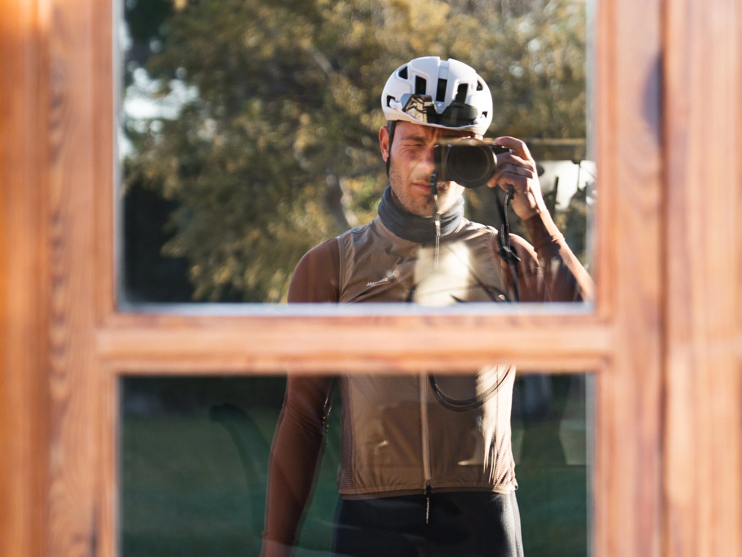 Rik de Voogd taking a photo of himself in a window reflection during a ride, capturing a moment on Mallorca early spring that inspired his shift from shooting for Instagram to real photography.