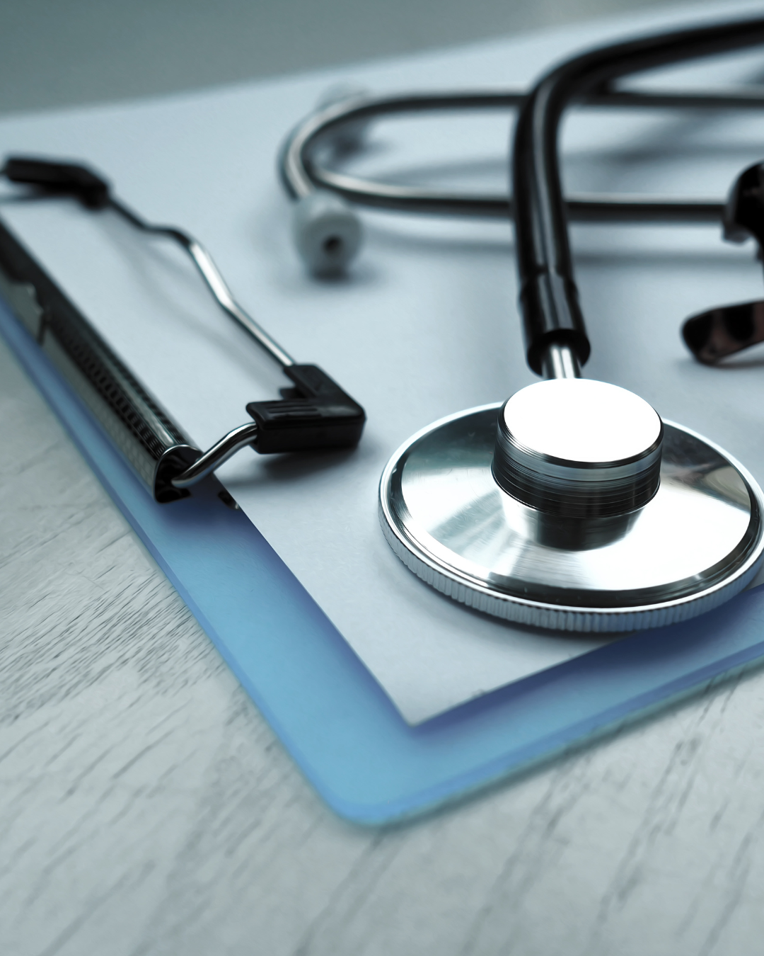 A stethoscope laying on top of a clipboard