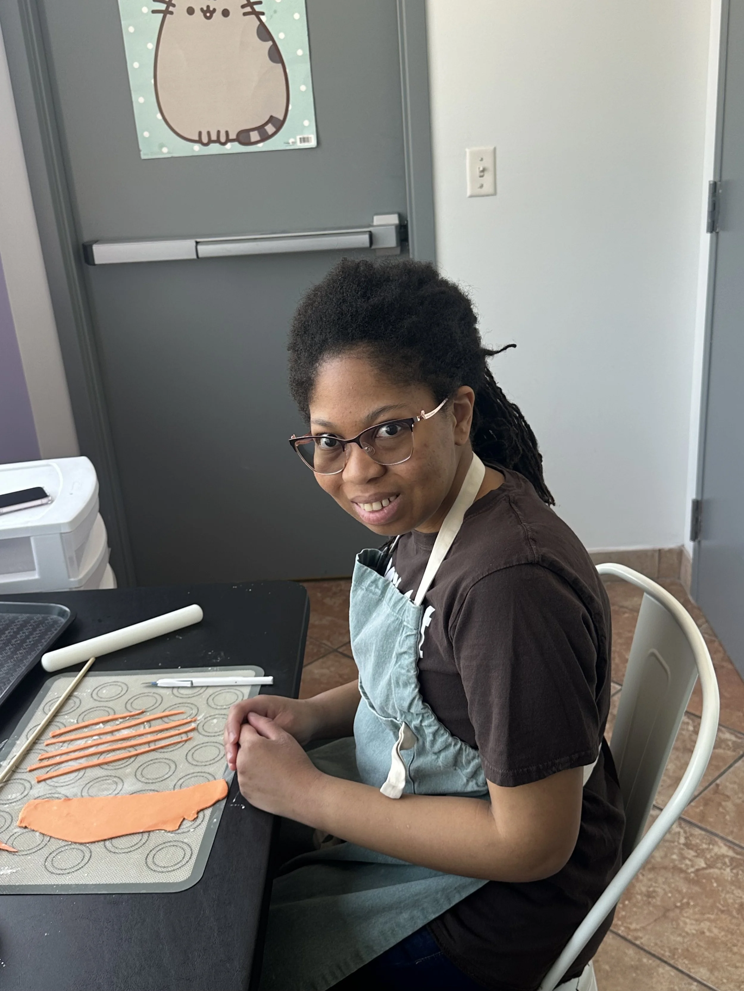 Adult smiling for photo while baking