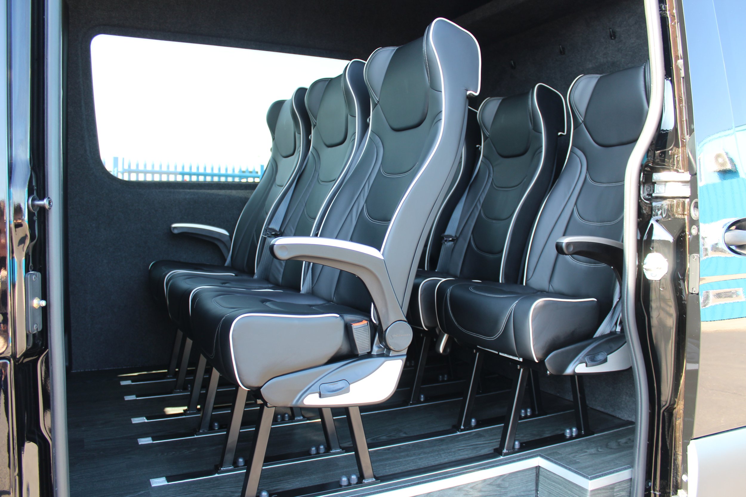 Ibex Touring' first tour bus with a forward-facing seating arrangement.