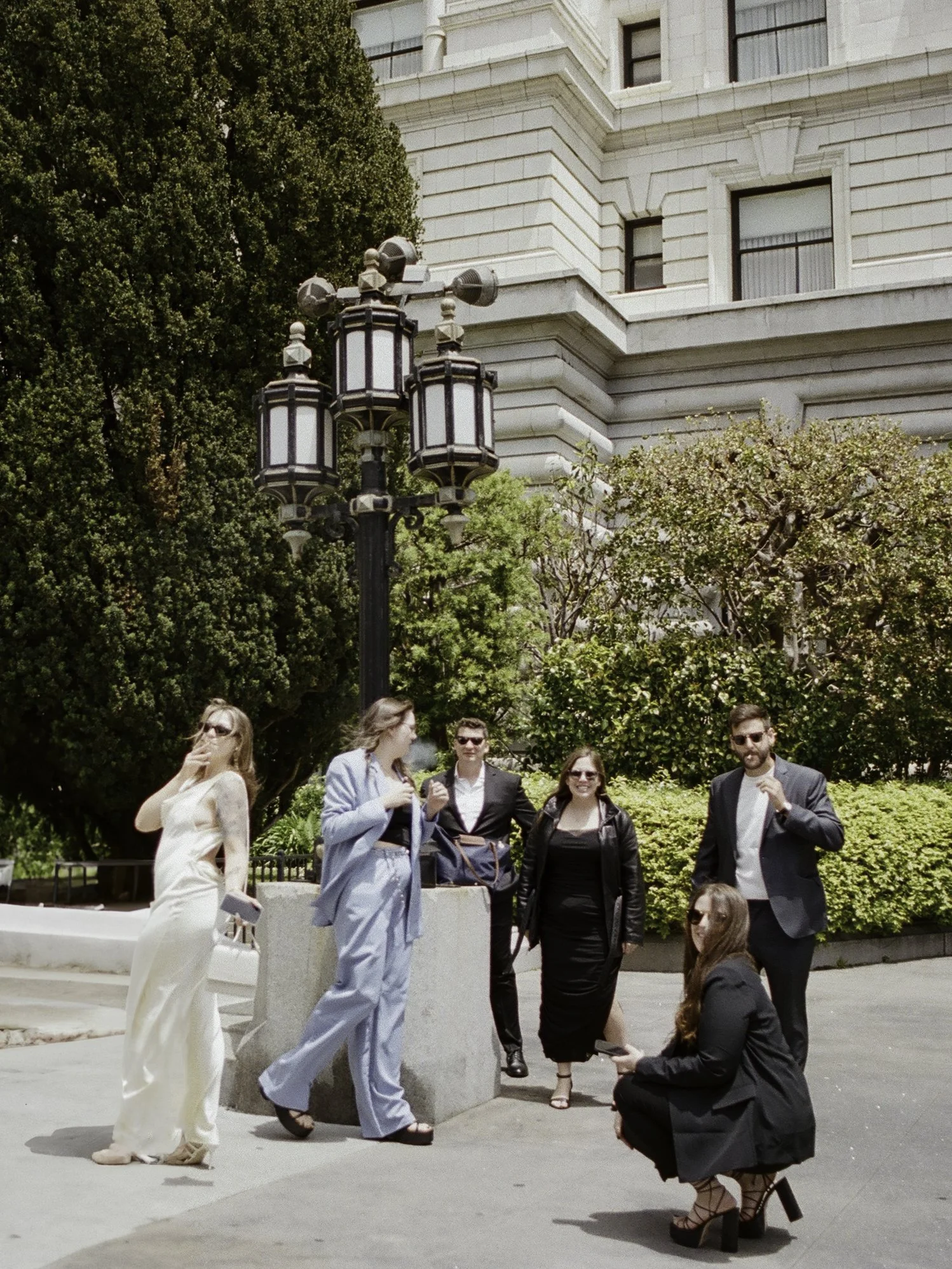 wedding guests gathered on the plaza outside san francisco city hall · group portrait · documentary film photography by radostina boseva