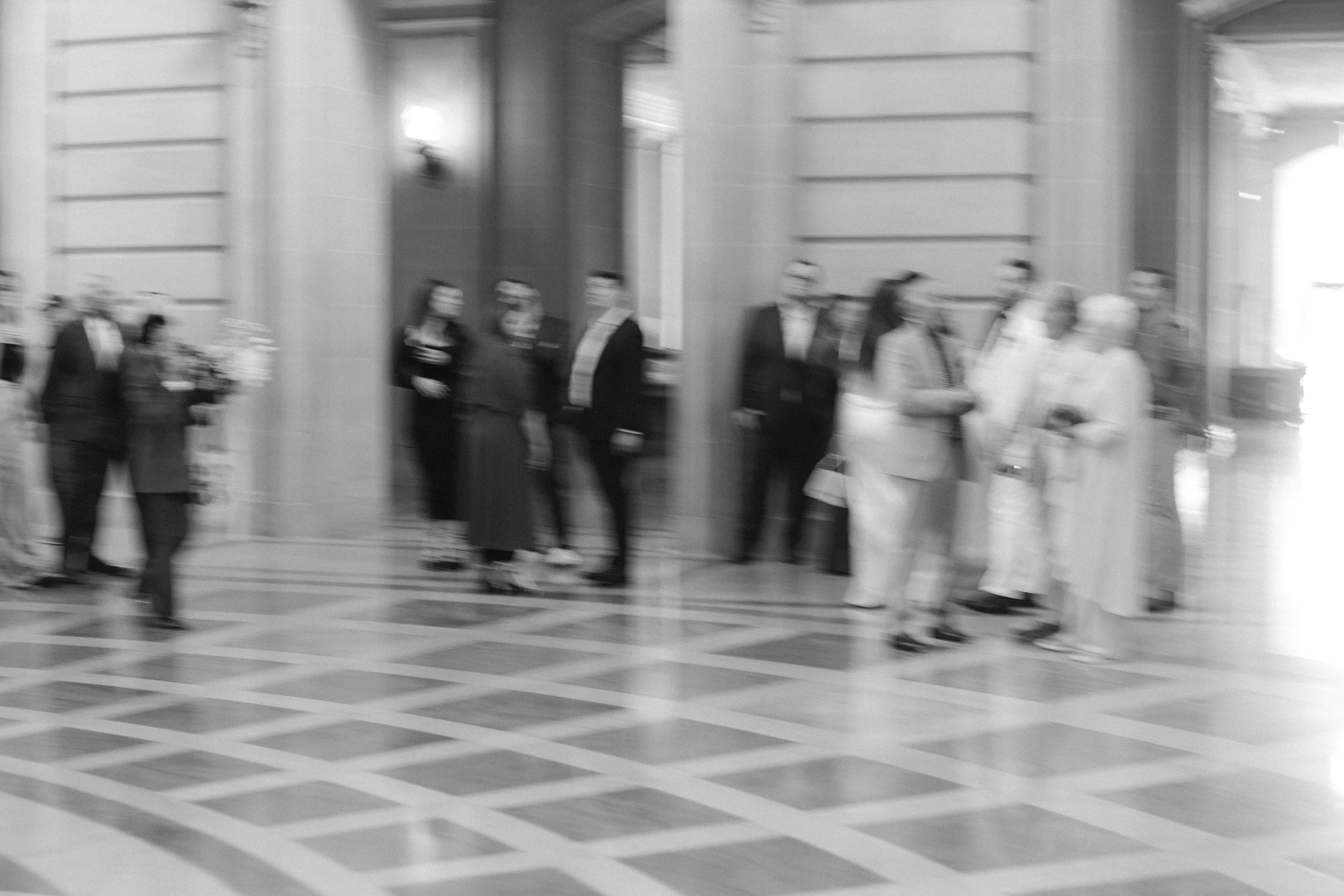 blurry film photo of wedding guests in san francsico city hall