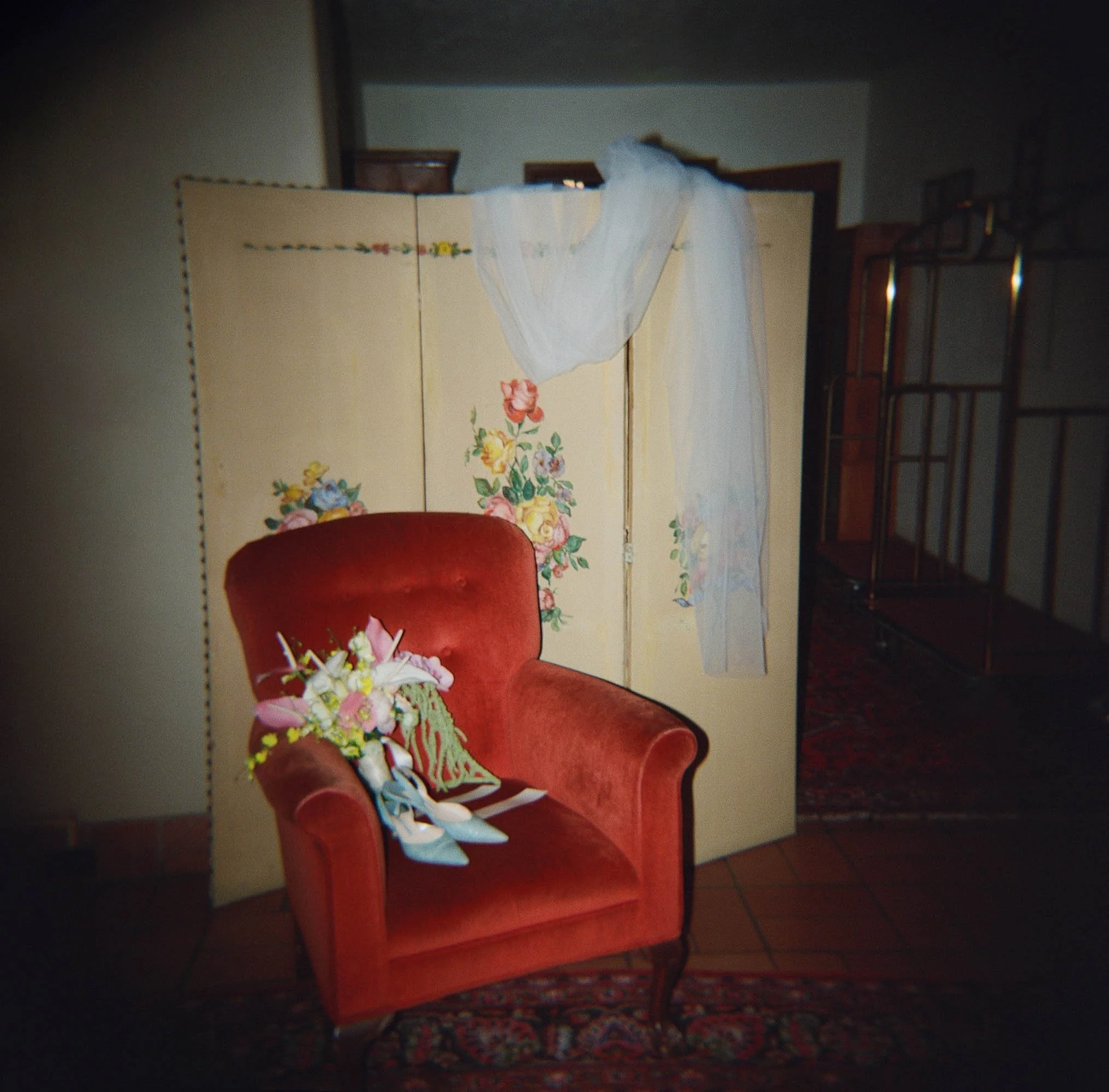 wedding veil draped over a folding screen beside a red velvet armchair  bay area getting ready · editorial film photography by radostina boseva