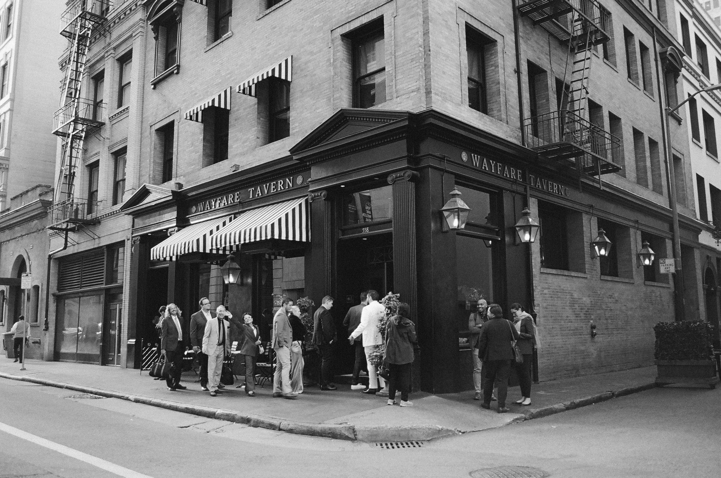 wedding guests gathering outside wayfare tavern after a san francisco city hall elopement · post-ceremony lunch · documentary film photography by radostina boseva