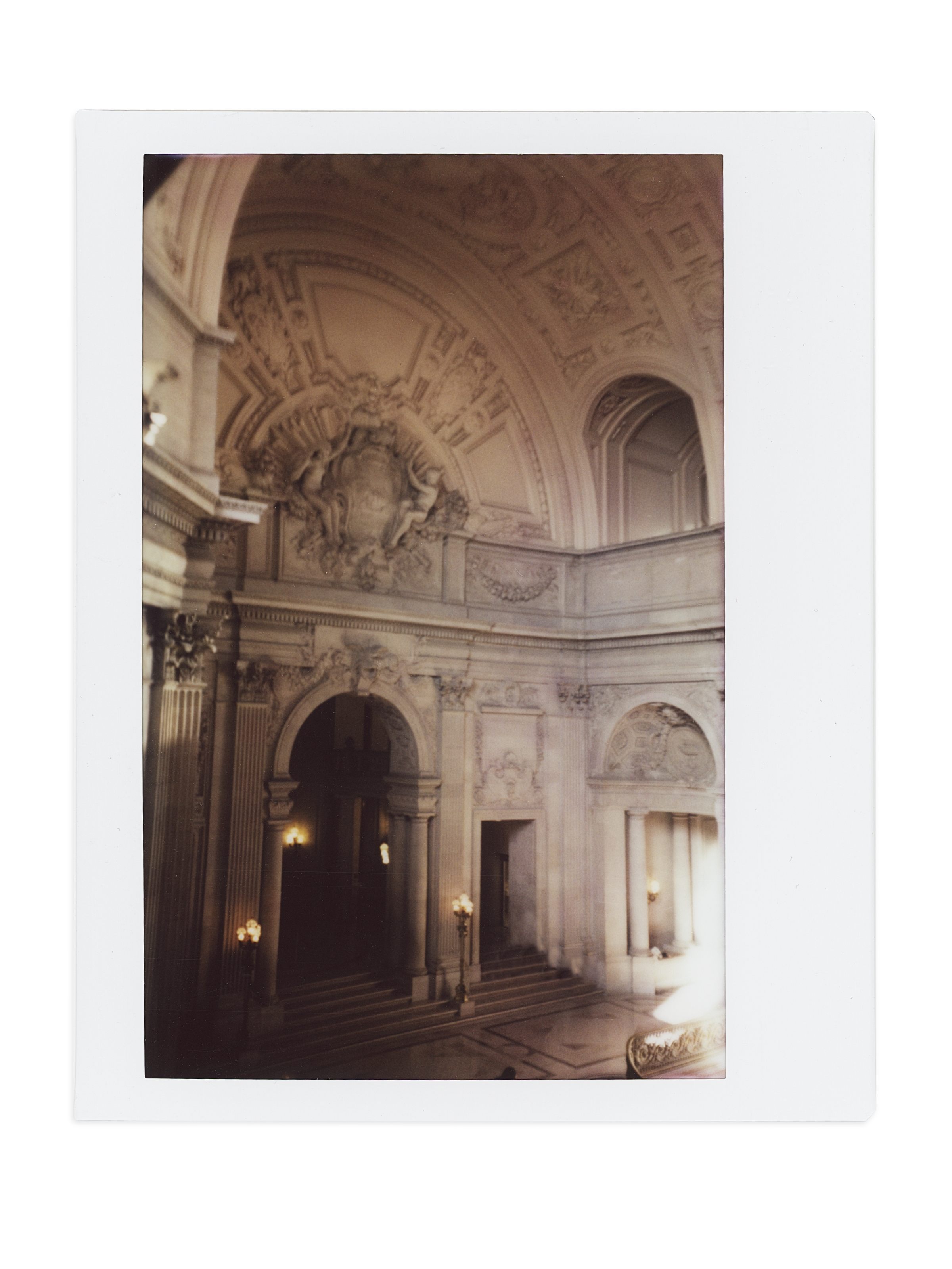 San Francisco City Hall grand hall interior with ornate arched ceiling and wall sconces, shot on instant film by Radostina Boseva