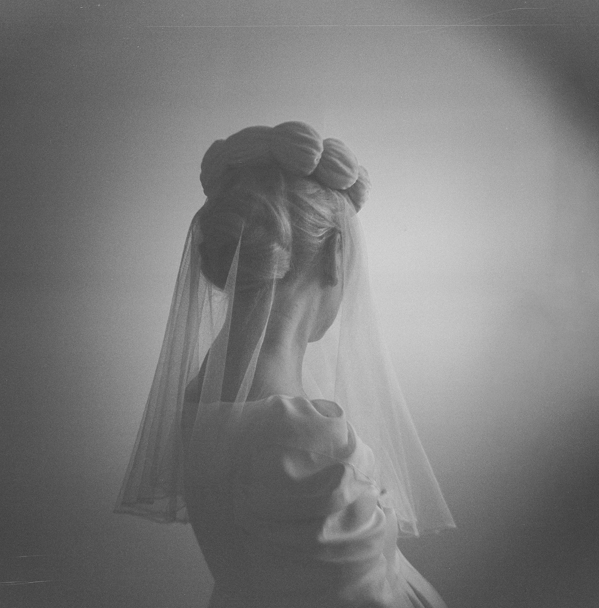 bride from behind with braided updo and veil, photographed on medium format film