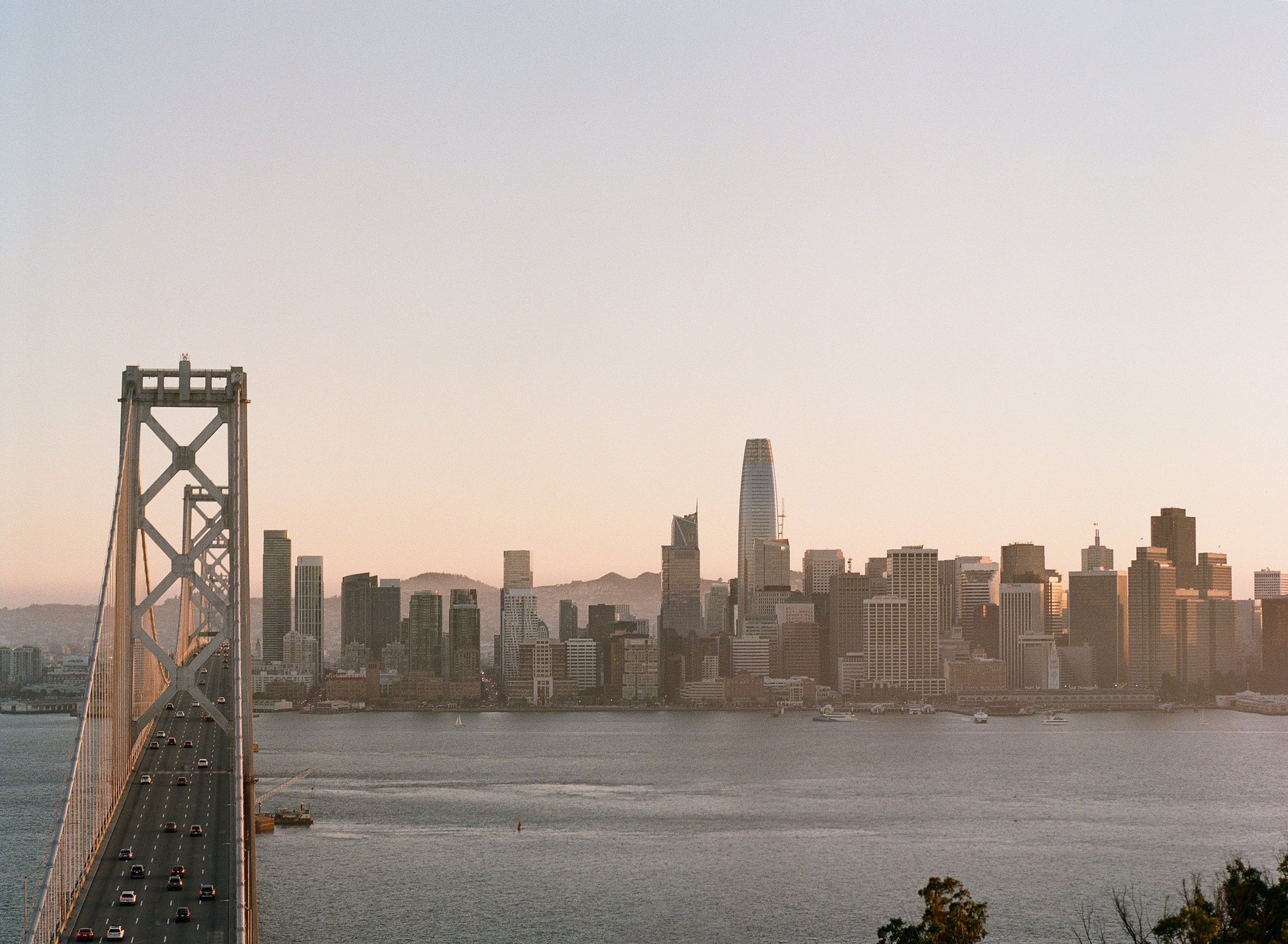 San Francisco skyline and Bay Bridge at golden hour, photographed on film by Radostina Boseva