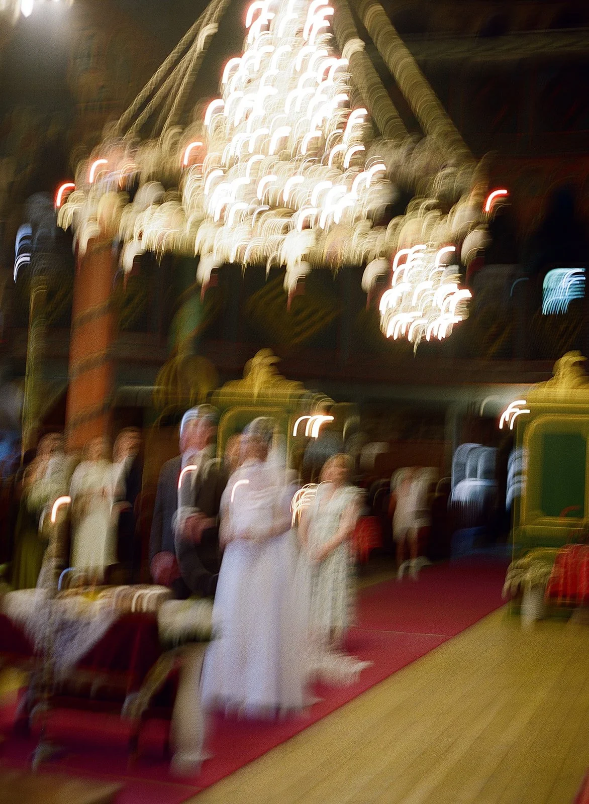 Wedding ceremony inside Bulgarian Orthodox church in Bansko with ornate chandelier and motion blur, destination wedding photographer Bulgaria