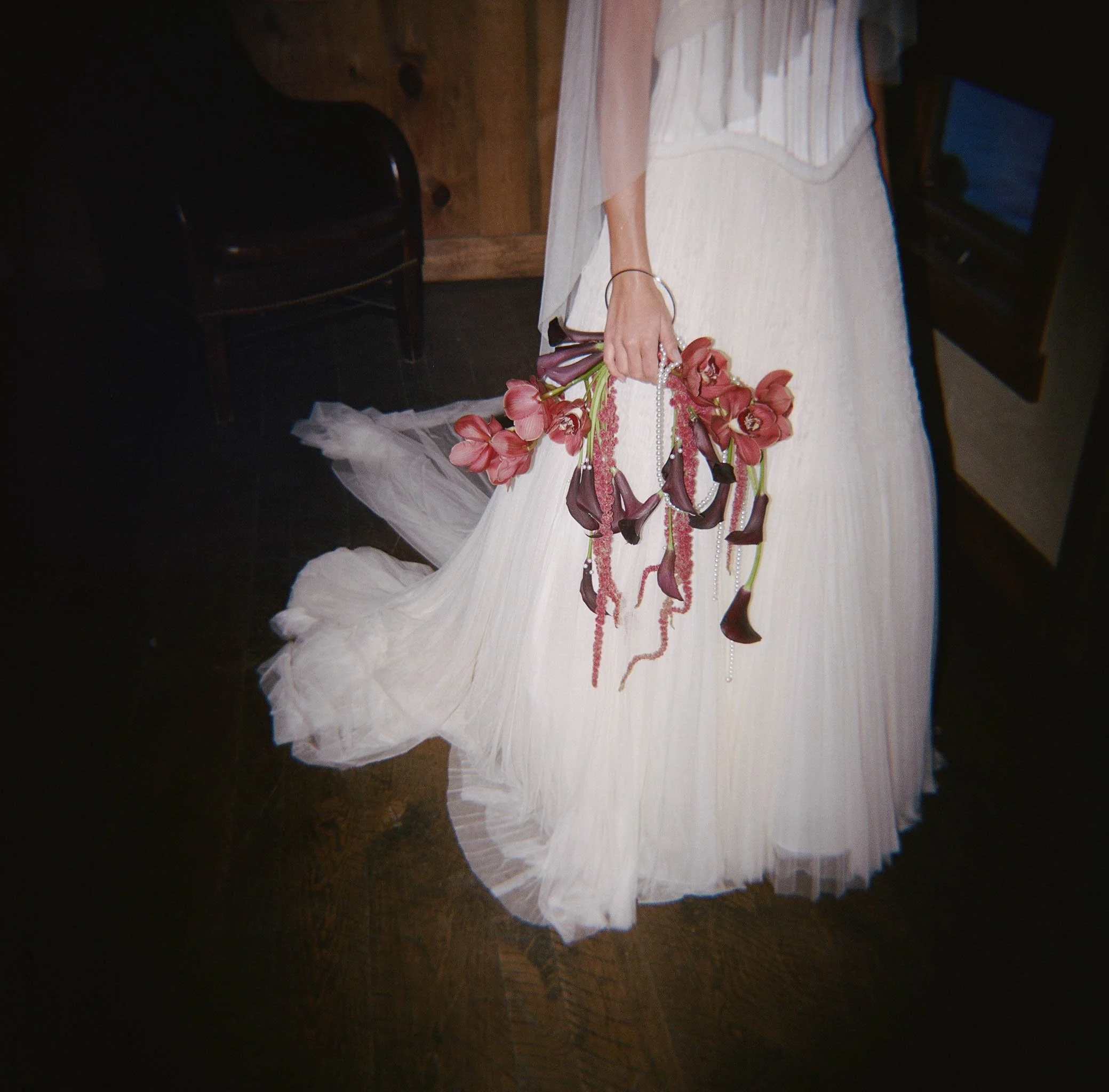 bride-holding-red-modern-bouquet