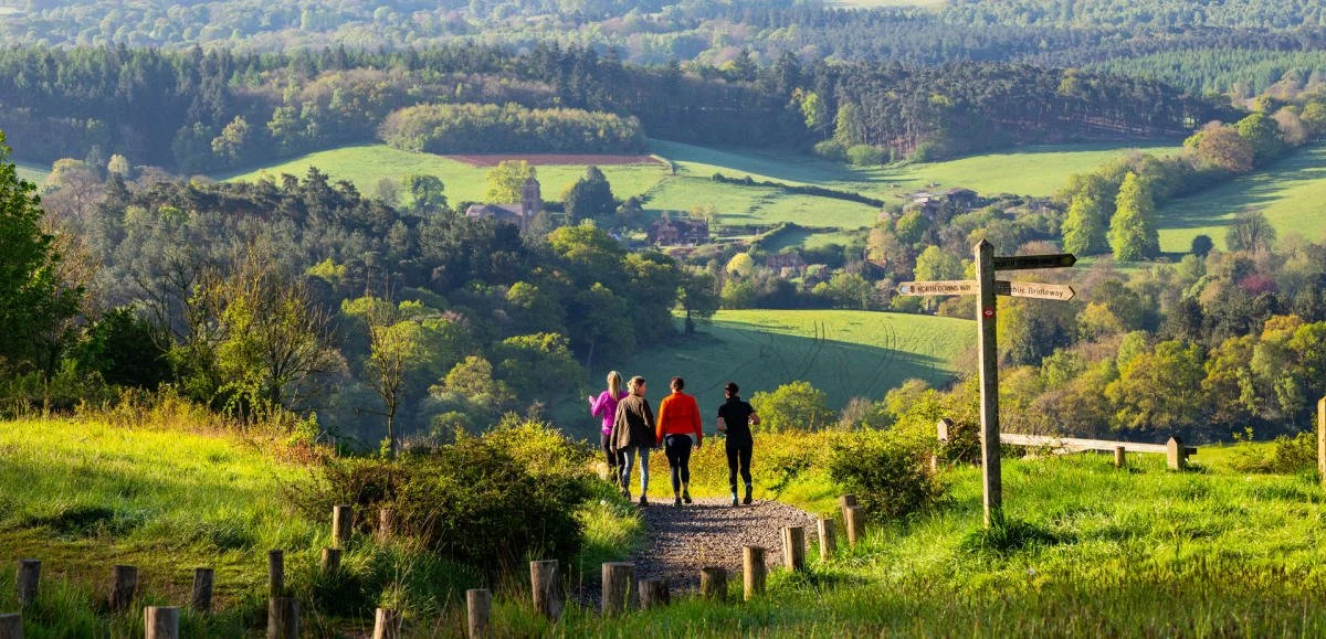 4 people running in the surrey countryside
