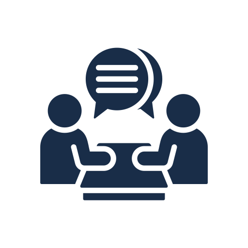 Two people sitting at a table engaged in a conversation, with speech bubbles above their heads.