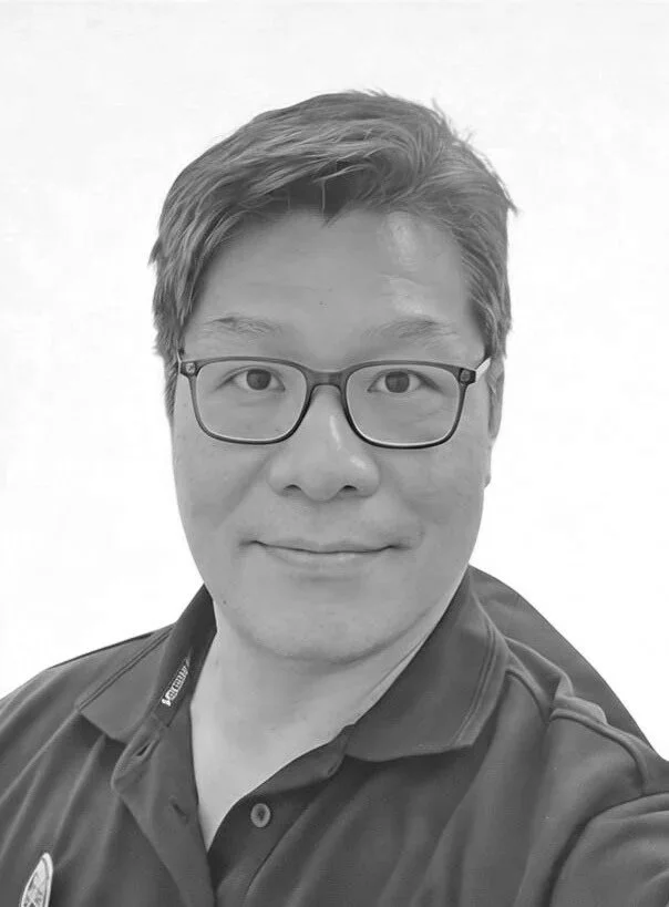 Friendly male smiling with dark hair and glasses