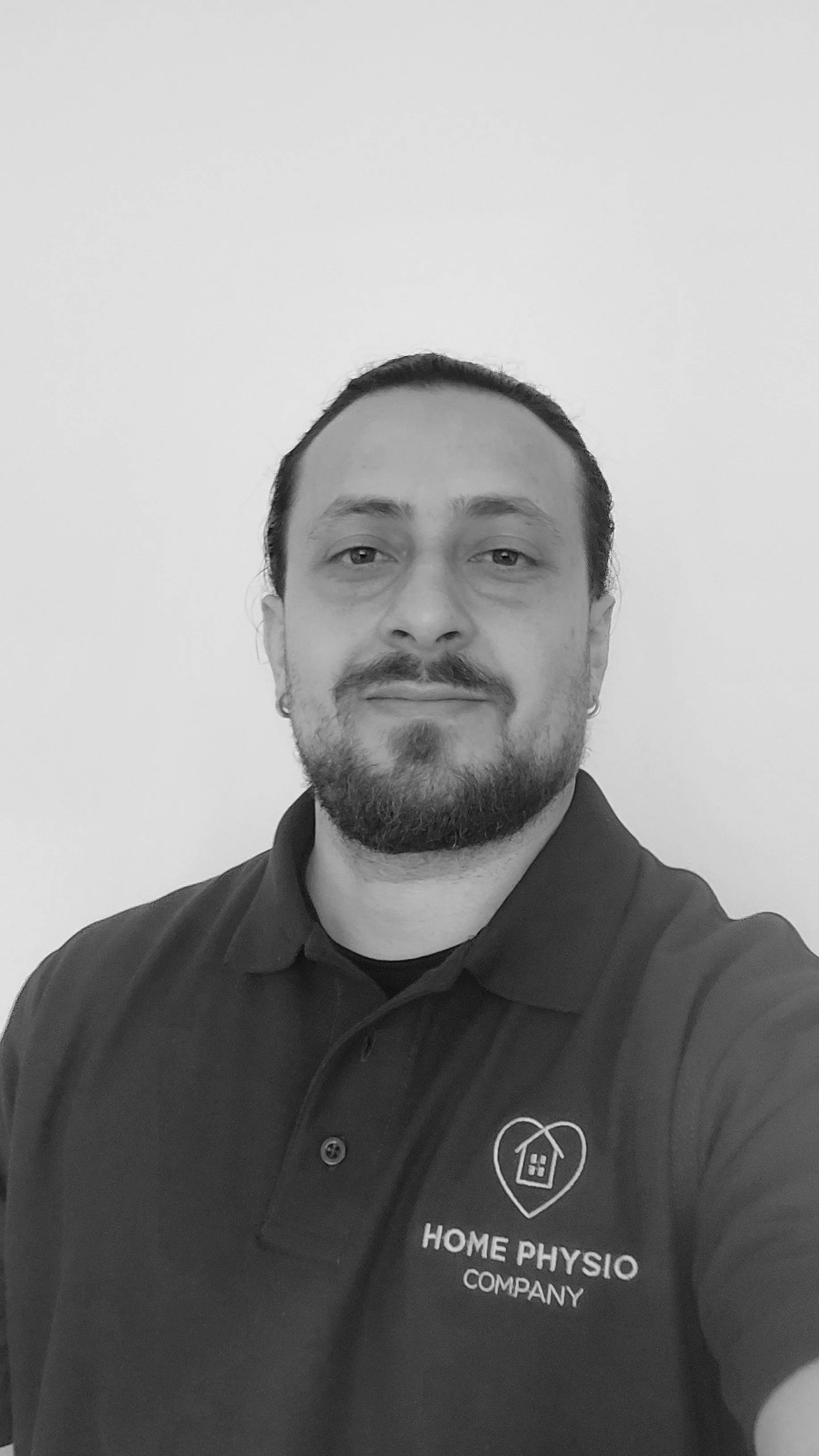 Woman holding physiotherapist plinth approaching a front door