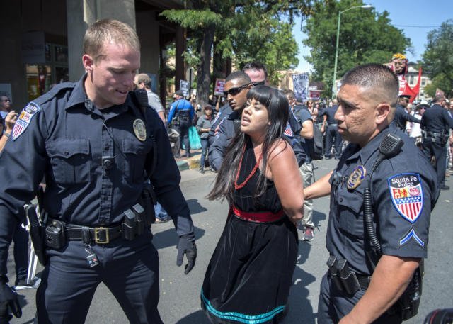 Native American charged with felony while protesting racisct event