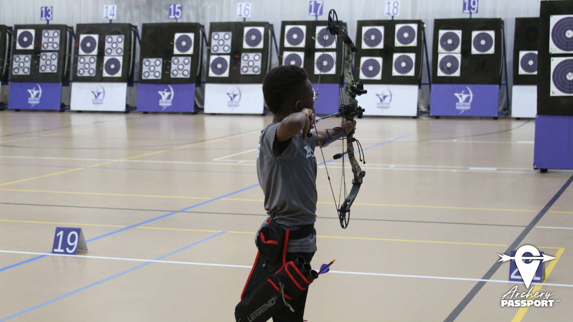 Male youth compound archer shooting indoors (Copy) (Copy) (Copy)