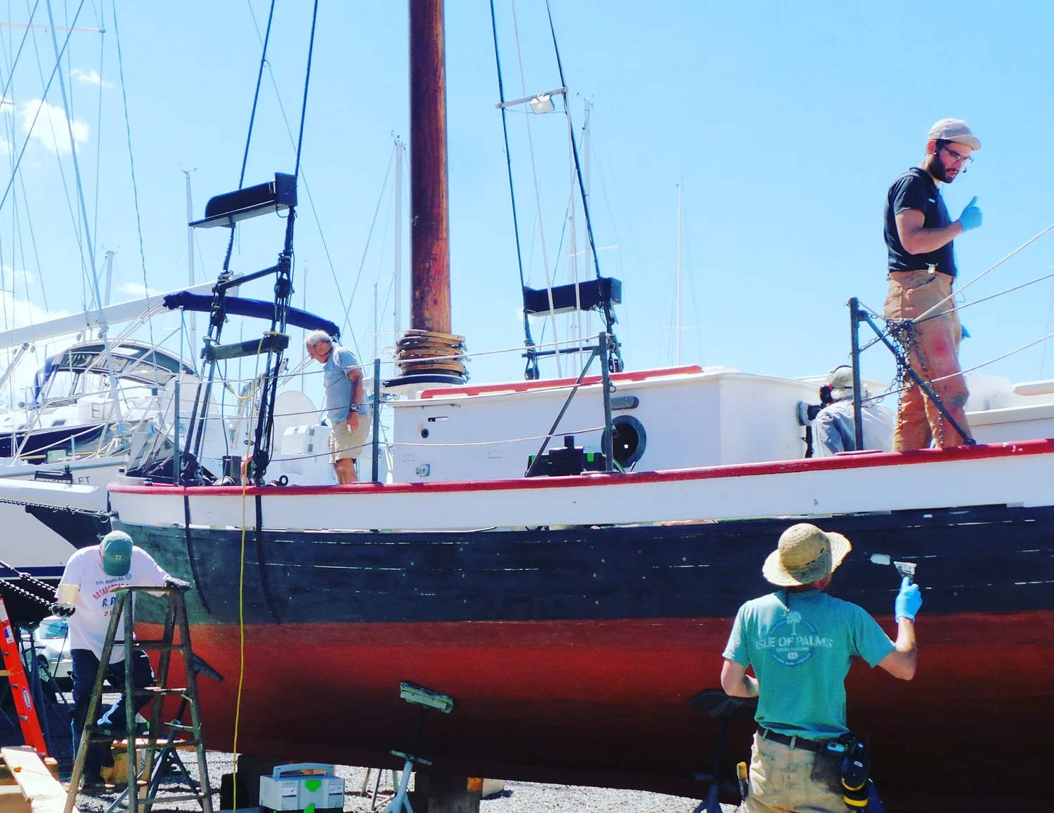 Volunteers and crew maintaining the hull of CHRISTEEN