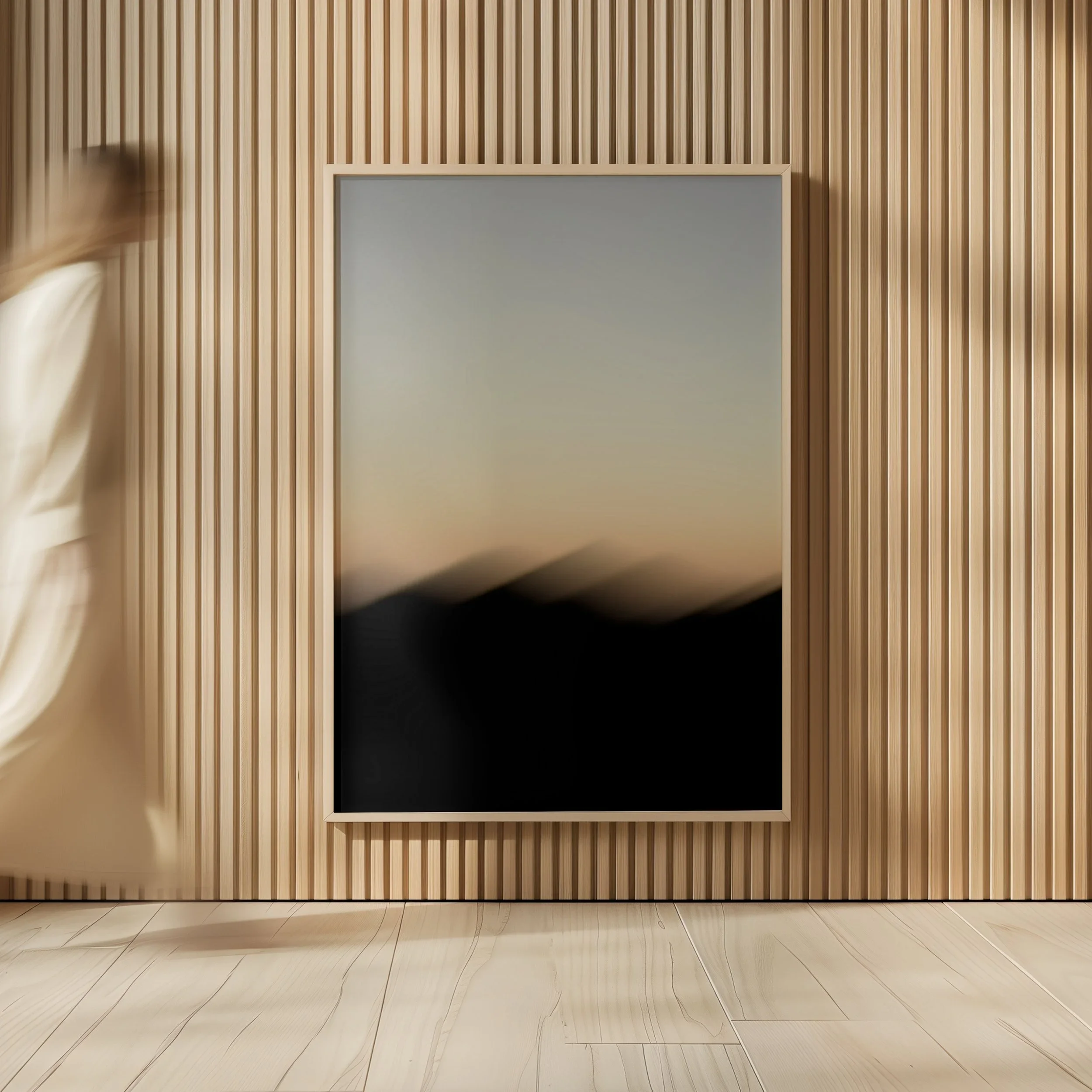 Blank framed artwork on a vertical wood-paneled wall above a light wood floor