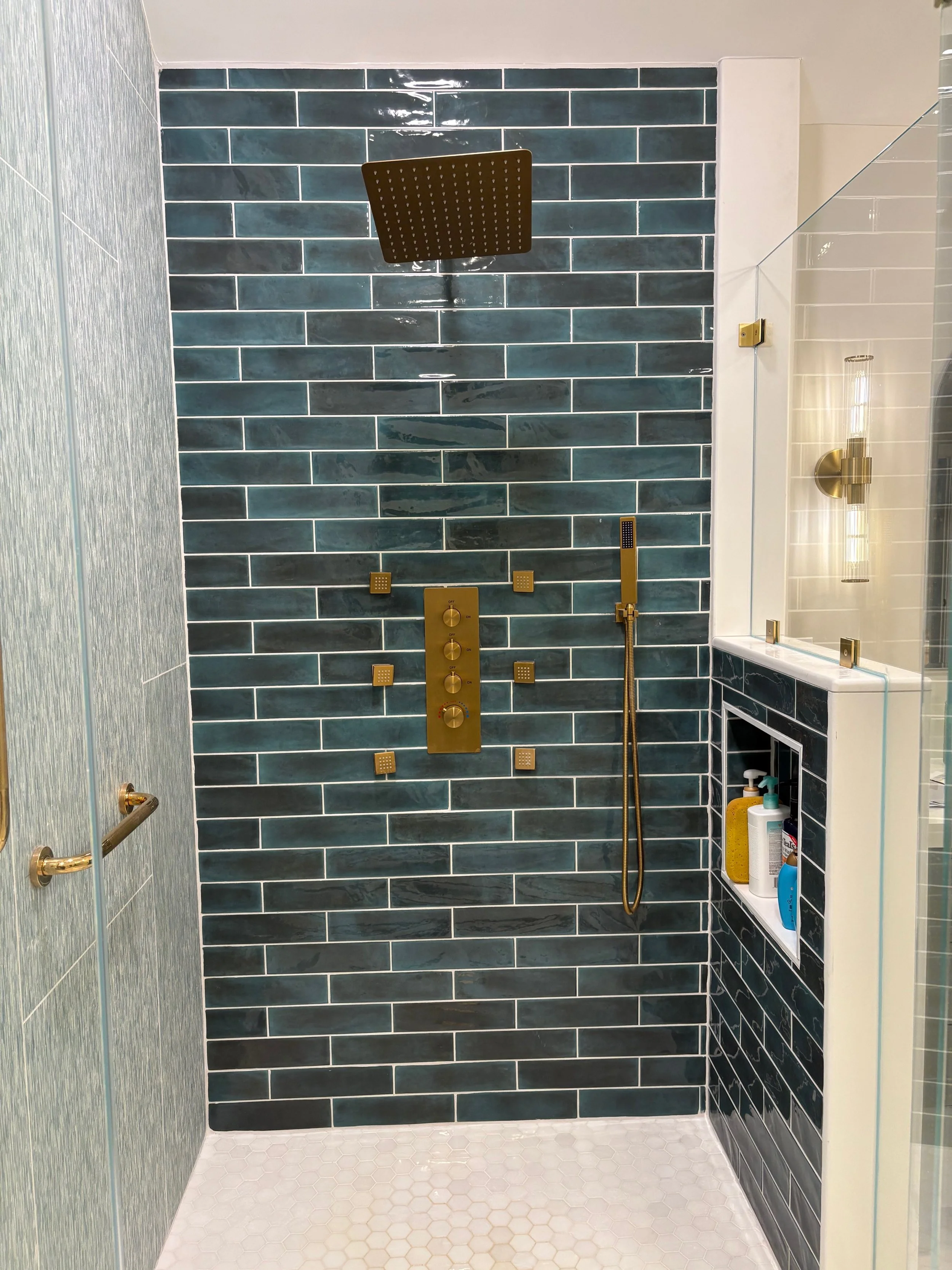 Shower with niche in pony wall and shower system in Newtown, CT