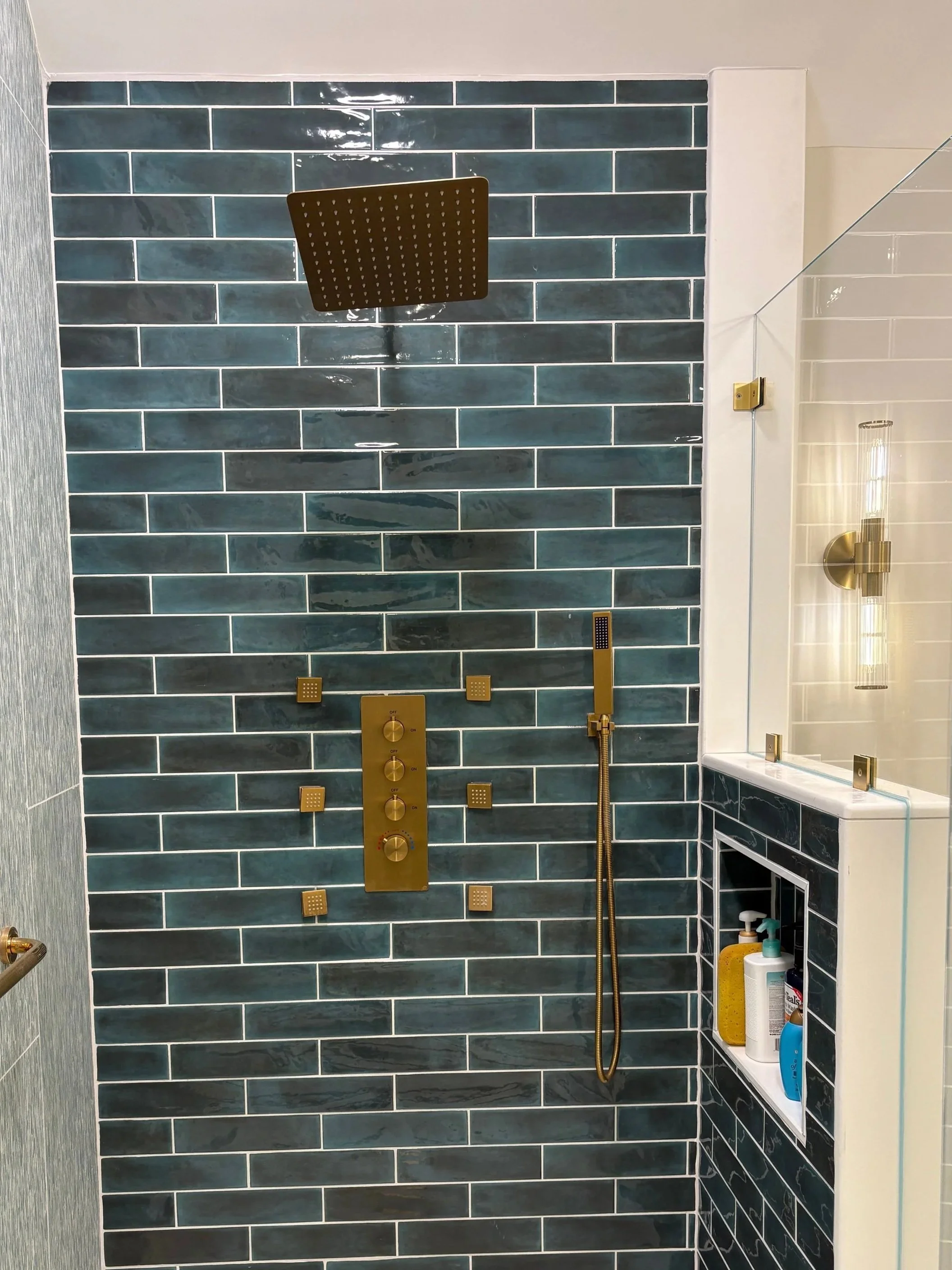 Shower wall with spacers between tiles.