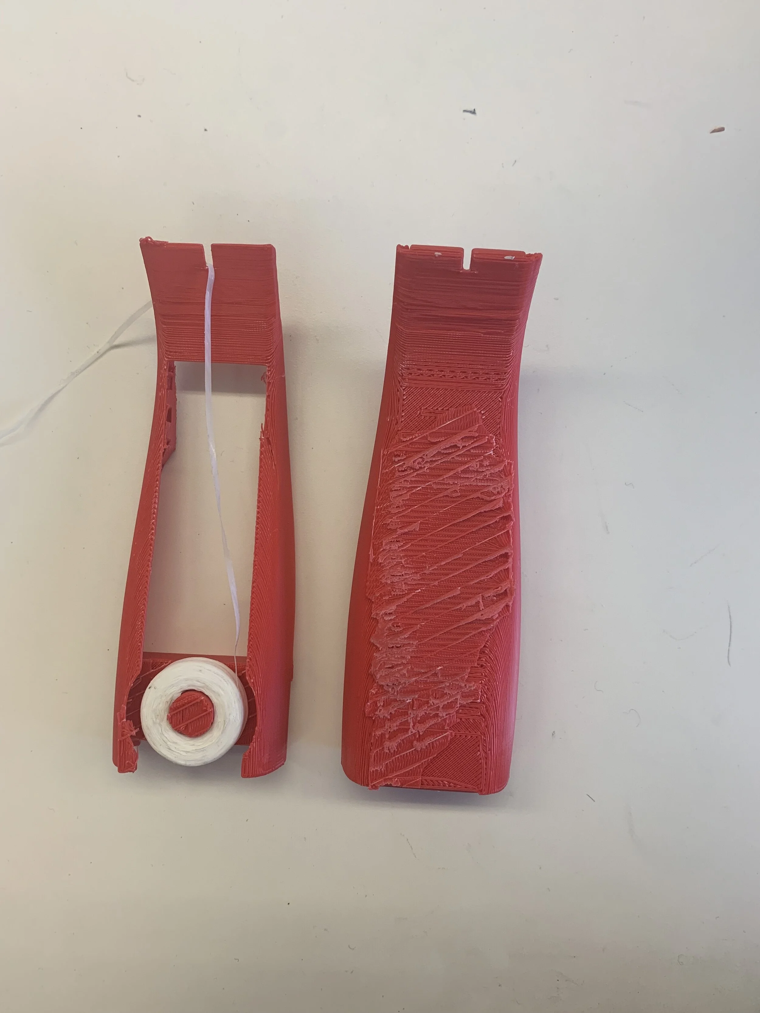Housing for the floss was placed at the bottom half of the product. From this prototype it was determined that low placement of the floss roll made the product awkward and unwieldy. The upper pick region of the part should also not be as wide as the 