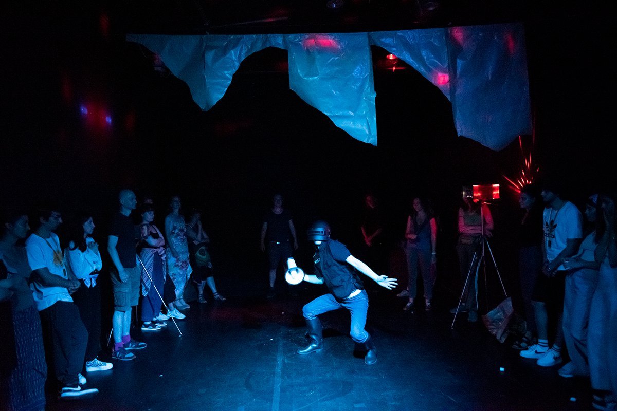 Audience watching police dance in Manifest Destiny by Ben Wippel at Tłusta Langusta