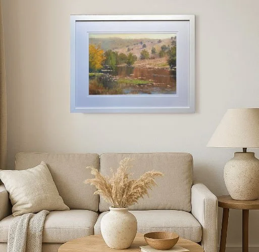 Framed oil australian landscape painting Macquarie by Frank Hodgert, showing a calm river, autumn trees, and distant hills. Displayed in white mat and frame with soft natural lighting