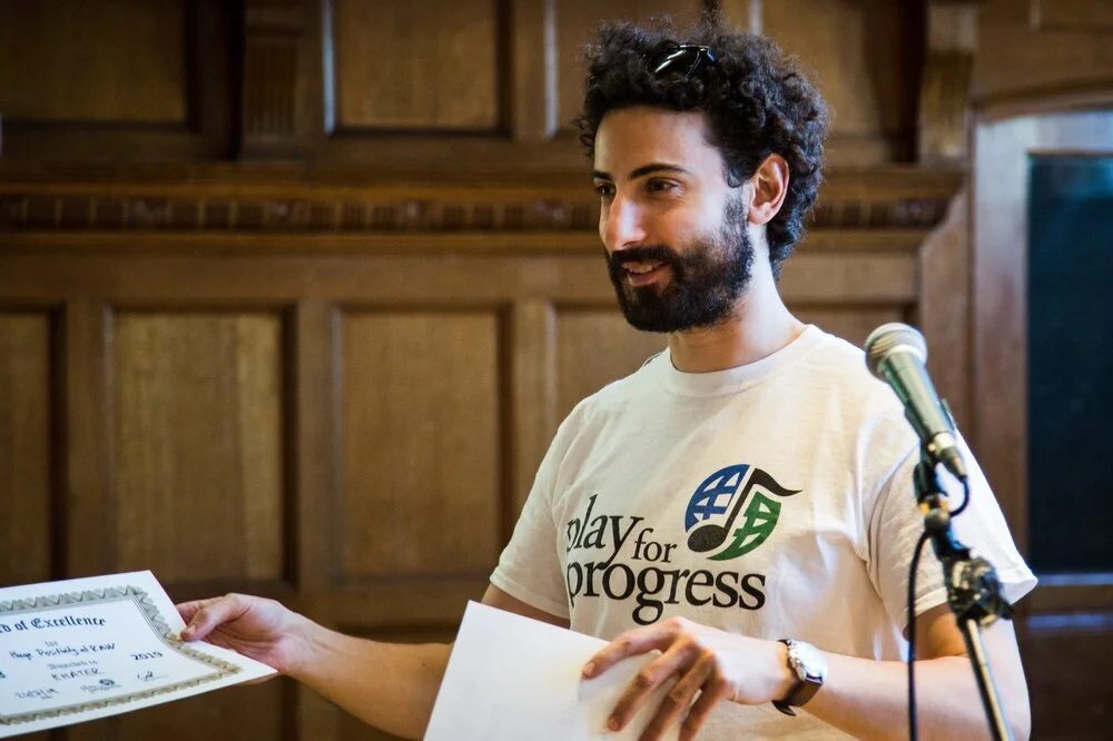 A PFP tutor giving out Certificates of Excellence to our young participants.