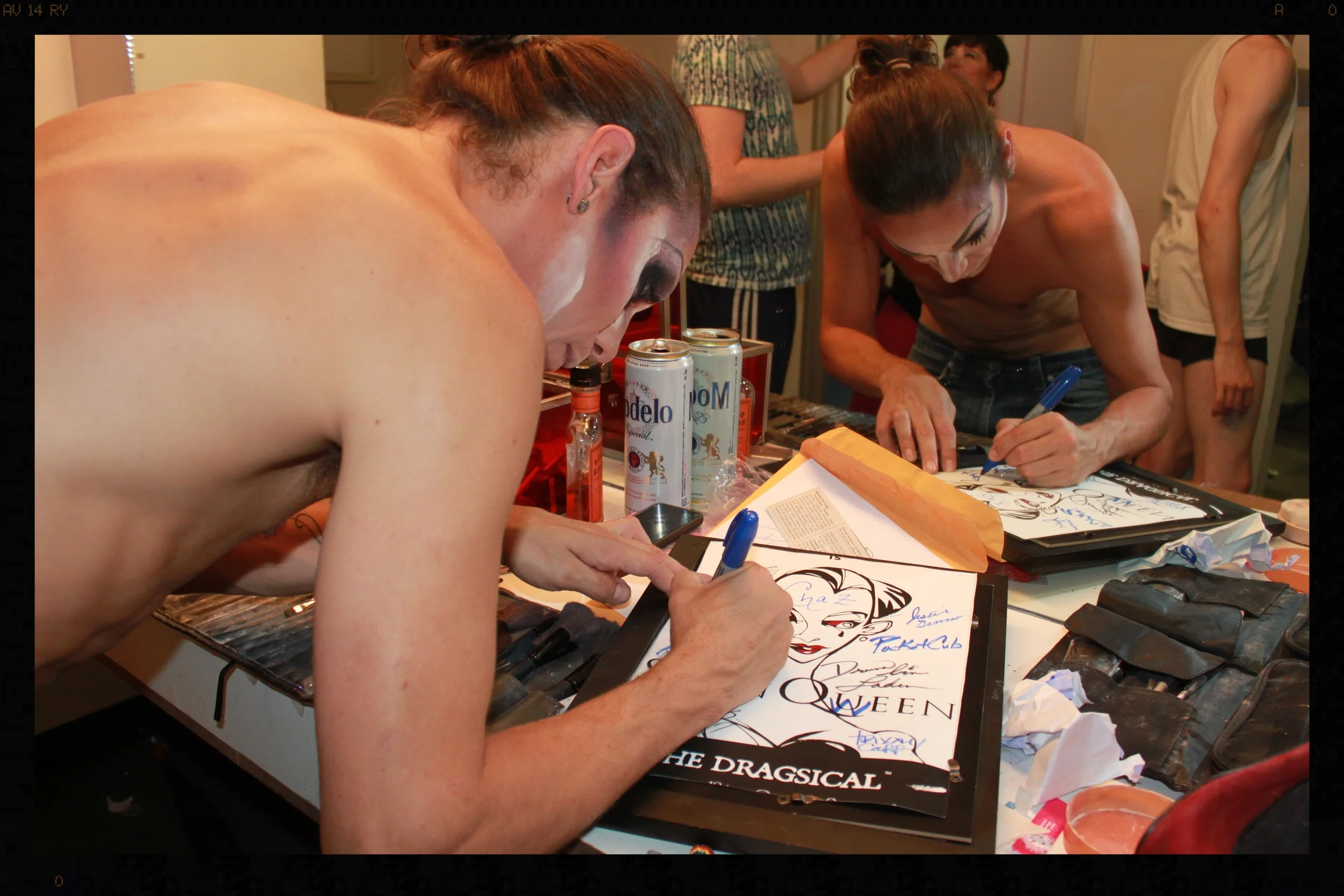  Doing it. &nbsp; Suppositori Spelling  signs a Swan Queen poster to be raffled for charity on opening night. 