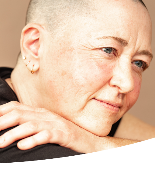 A queer woman posing and looking off into the distance