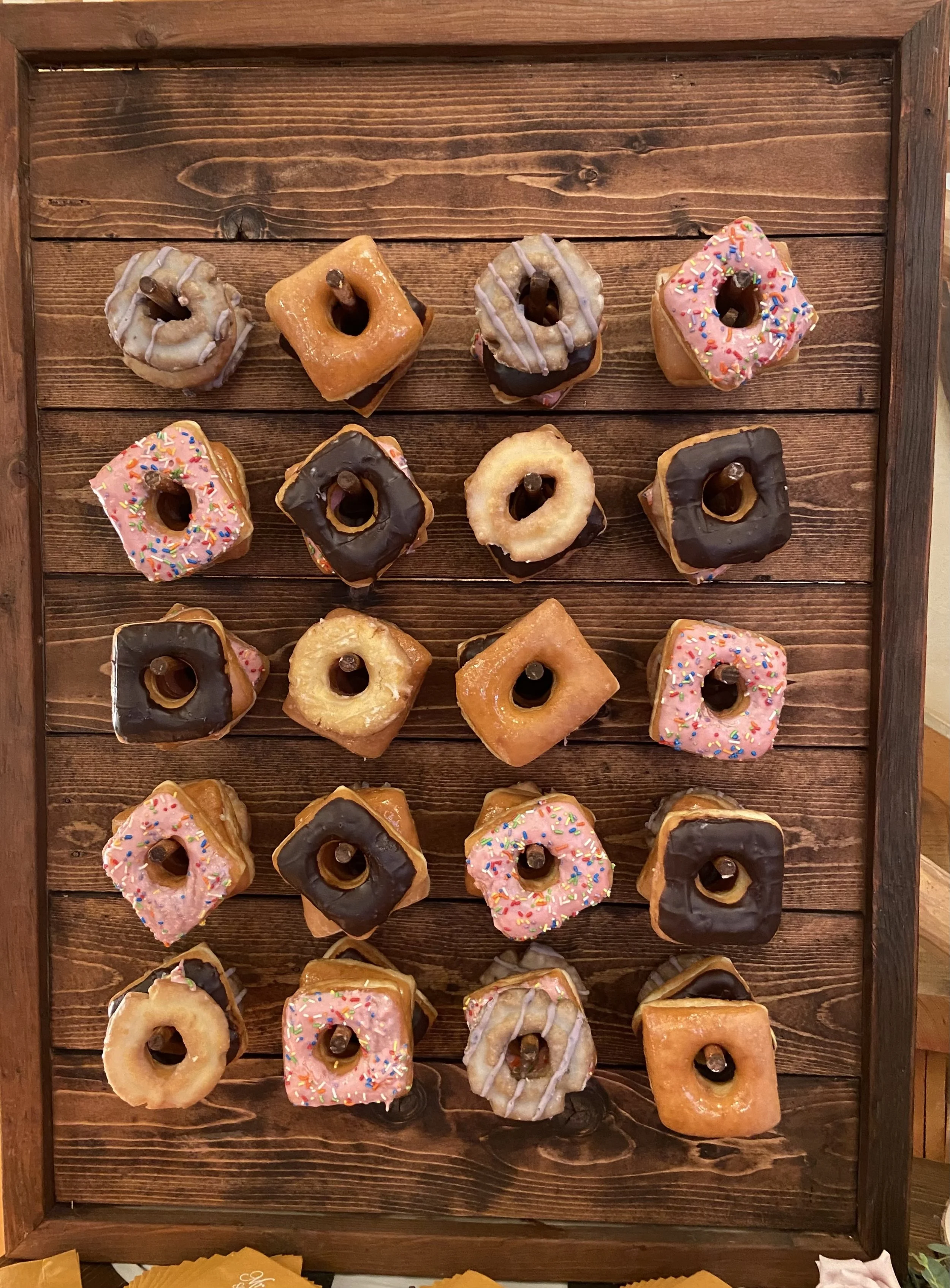 A donut wall filled with homemade beef fat donuts available as a dessert station add-on for catered events by Lone Peak Provisions in Bozeman, Montana.