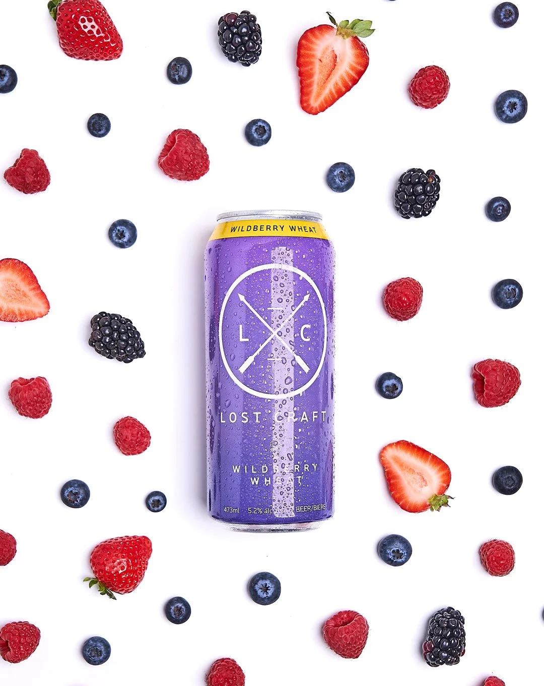 Beverage photography with berries around the can