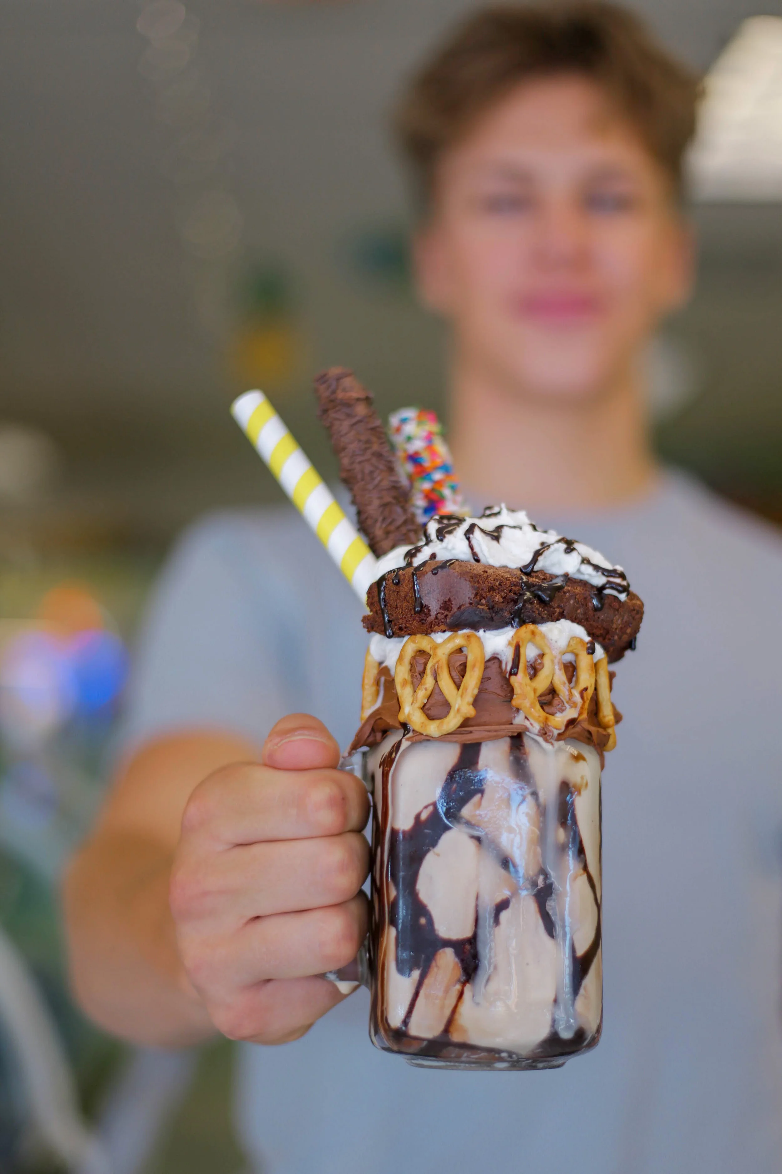 Man holding a chocolate ice cream shake