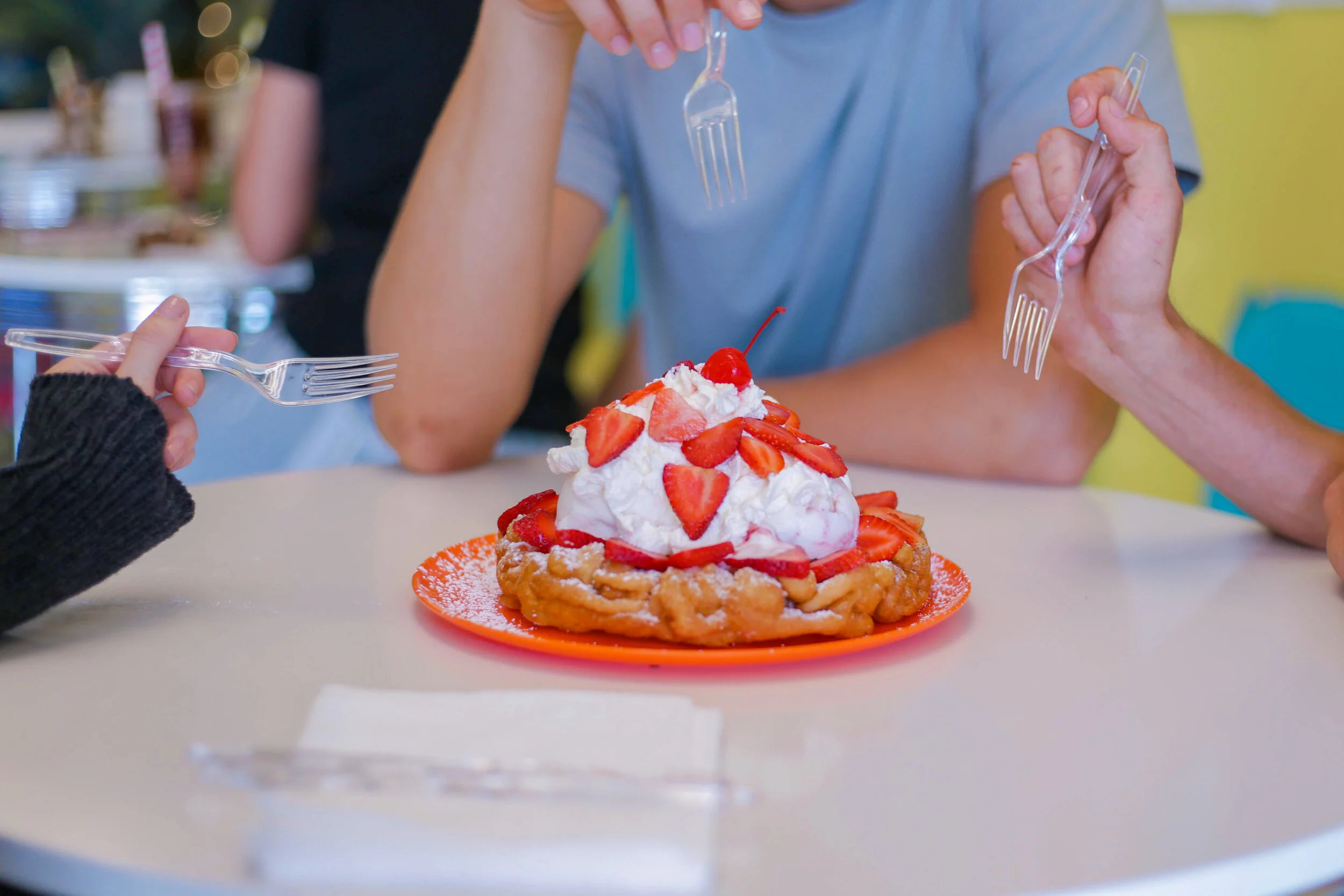 Funnel cake with whipped cream and strawberries