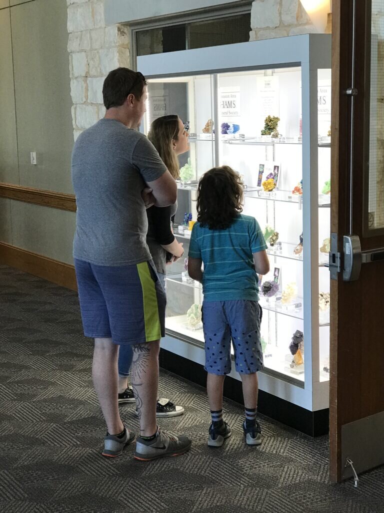 Two future advanced collectors and their dad admire the HAMS case.