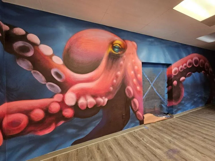 Lase 28 mural artist at work in California
