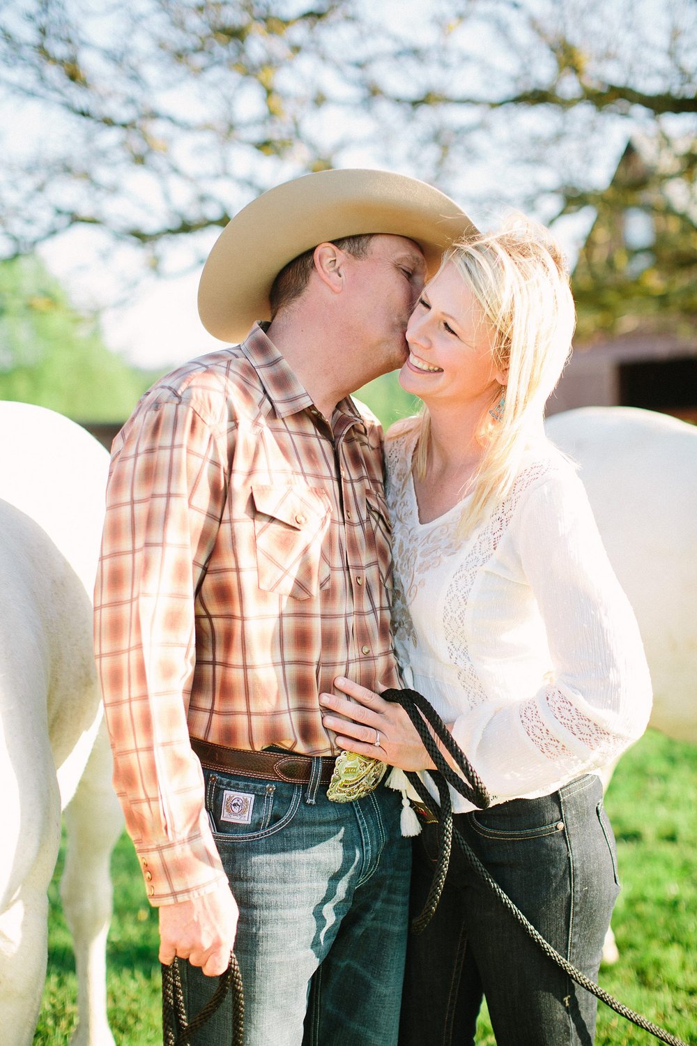 cowboy in rural washington kissing bride