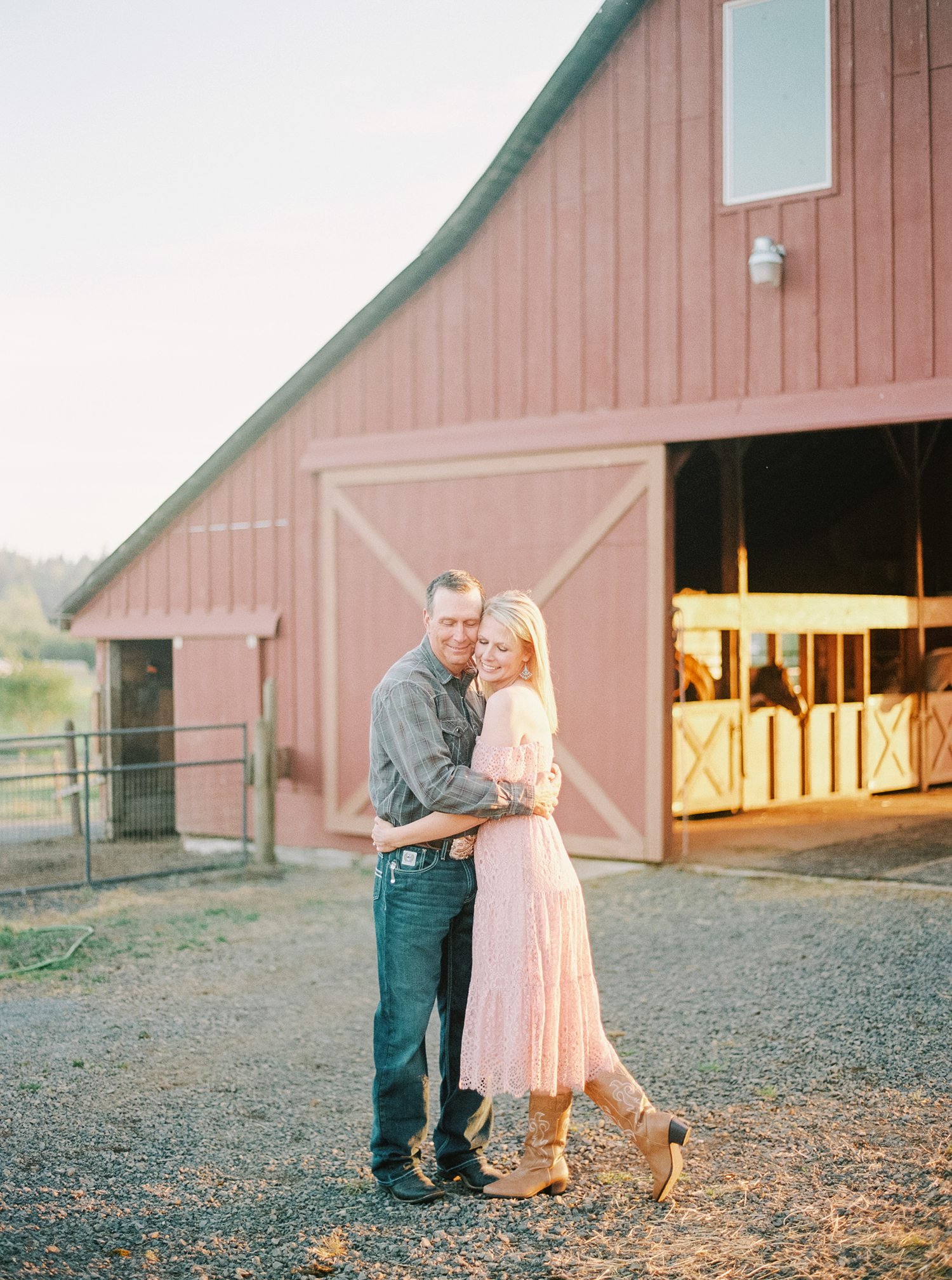 engagement session by the barn where wedding will take place
